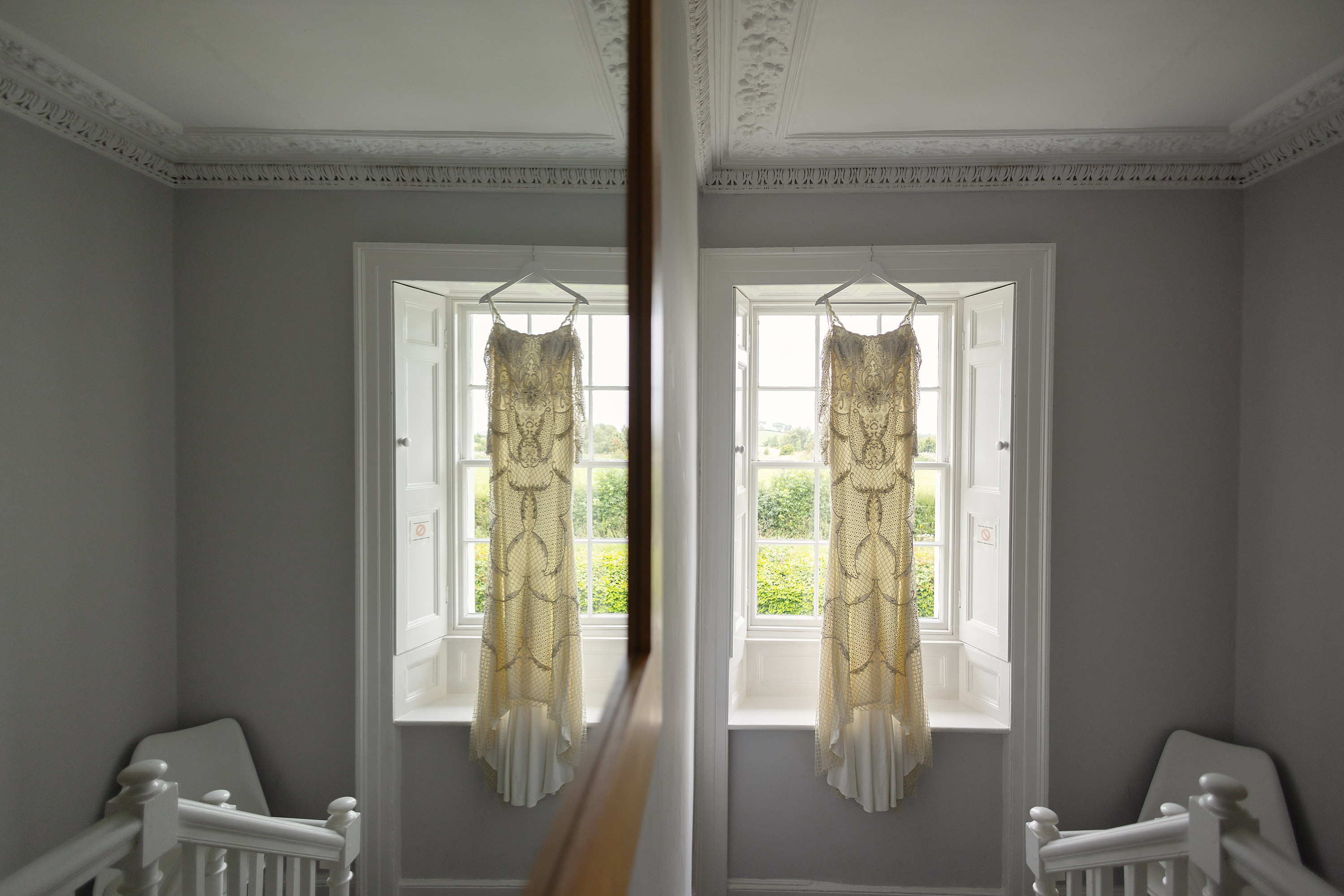 The bride wedding dress hanging in the window 