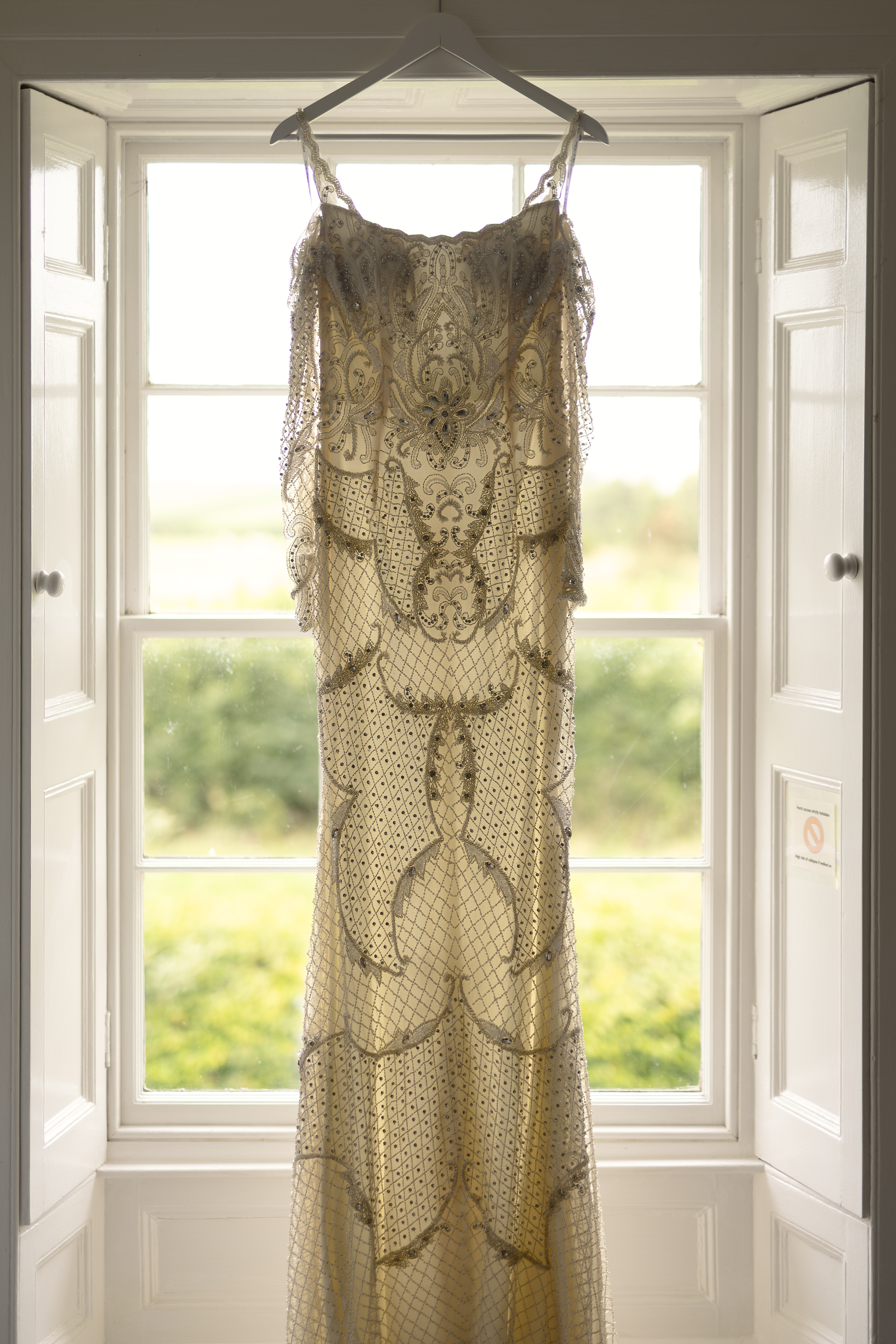 The bride wedding dress hanging in the window 