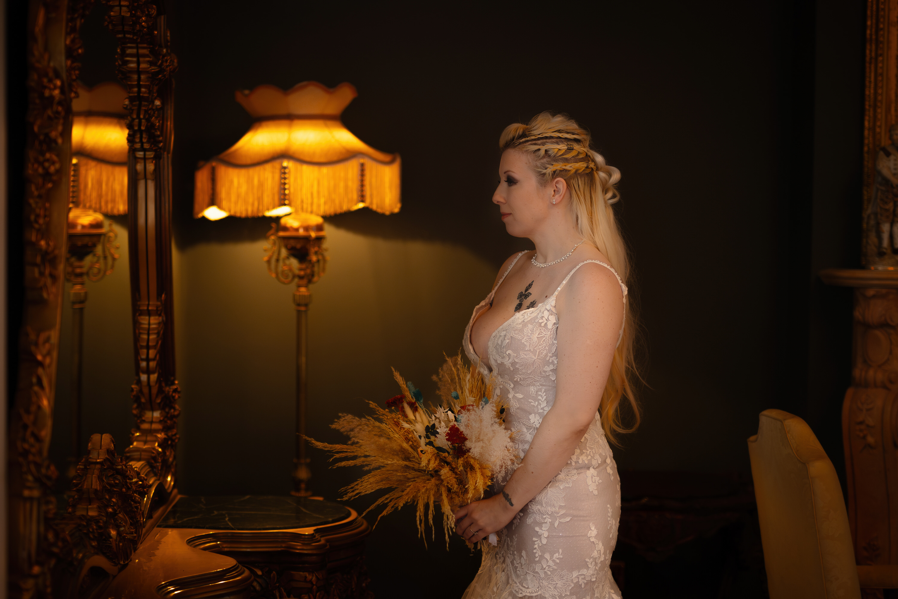 The Bride gets into her wedding dress and looks at herself in the mirror 