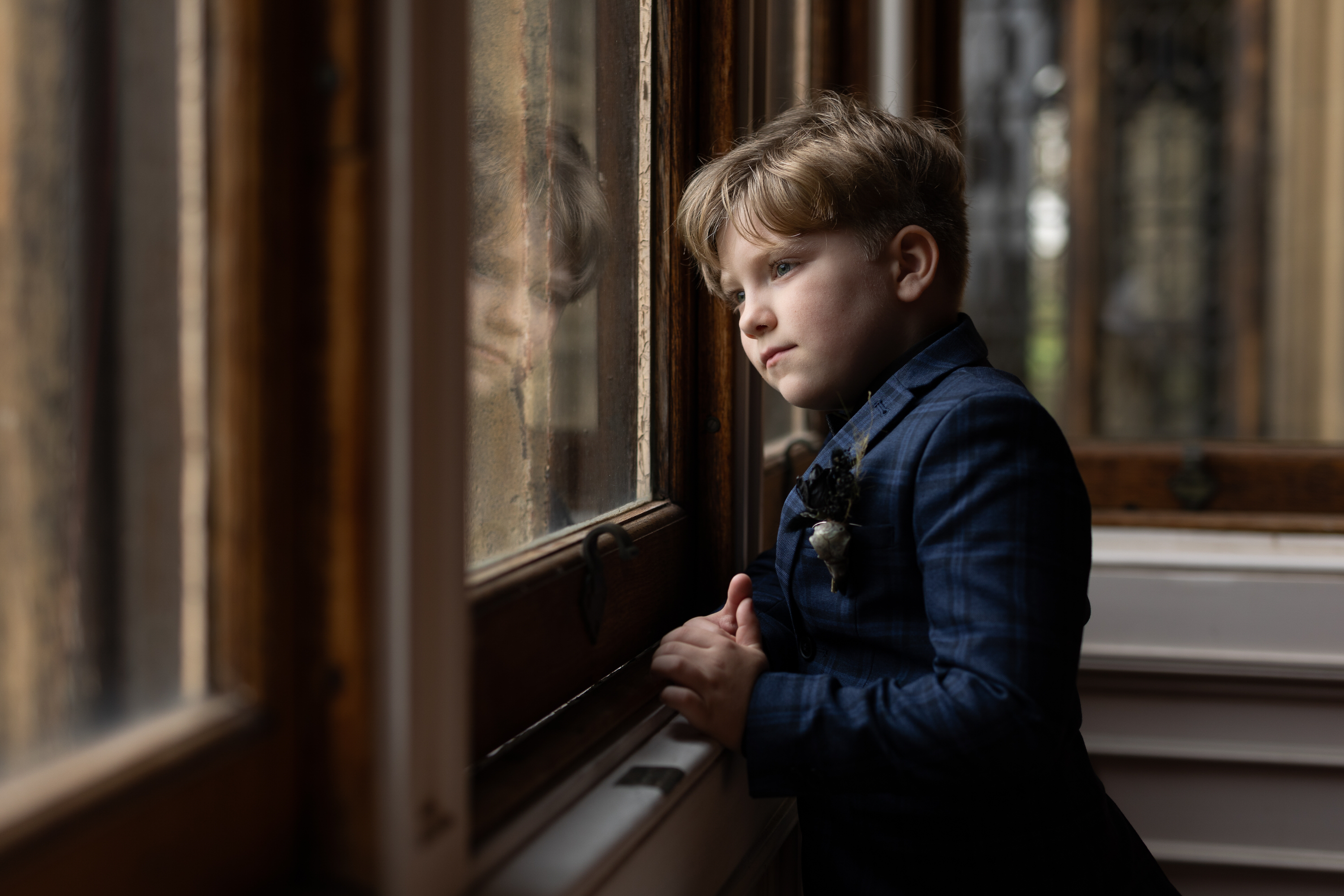 The brides son looking out of the window at Allerton Castle