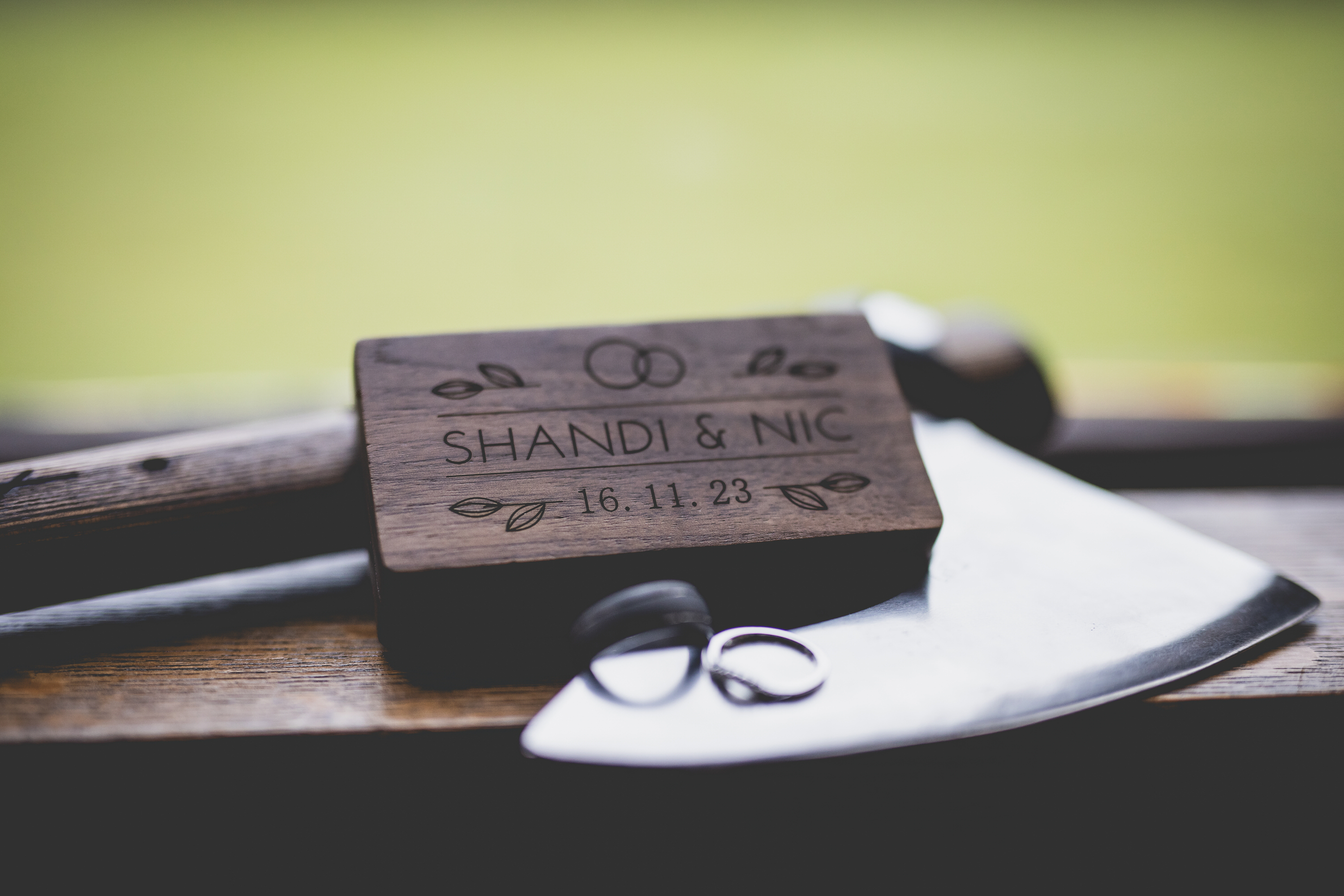 The bride and grooms wedding rings with a Viking axe 