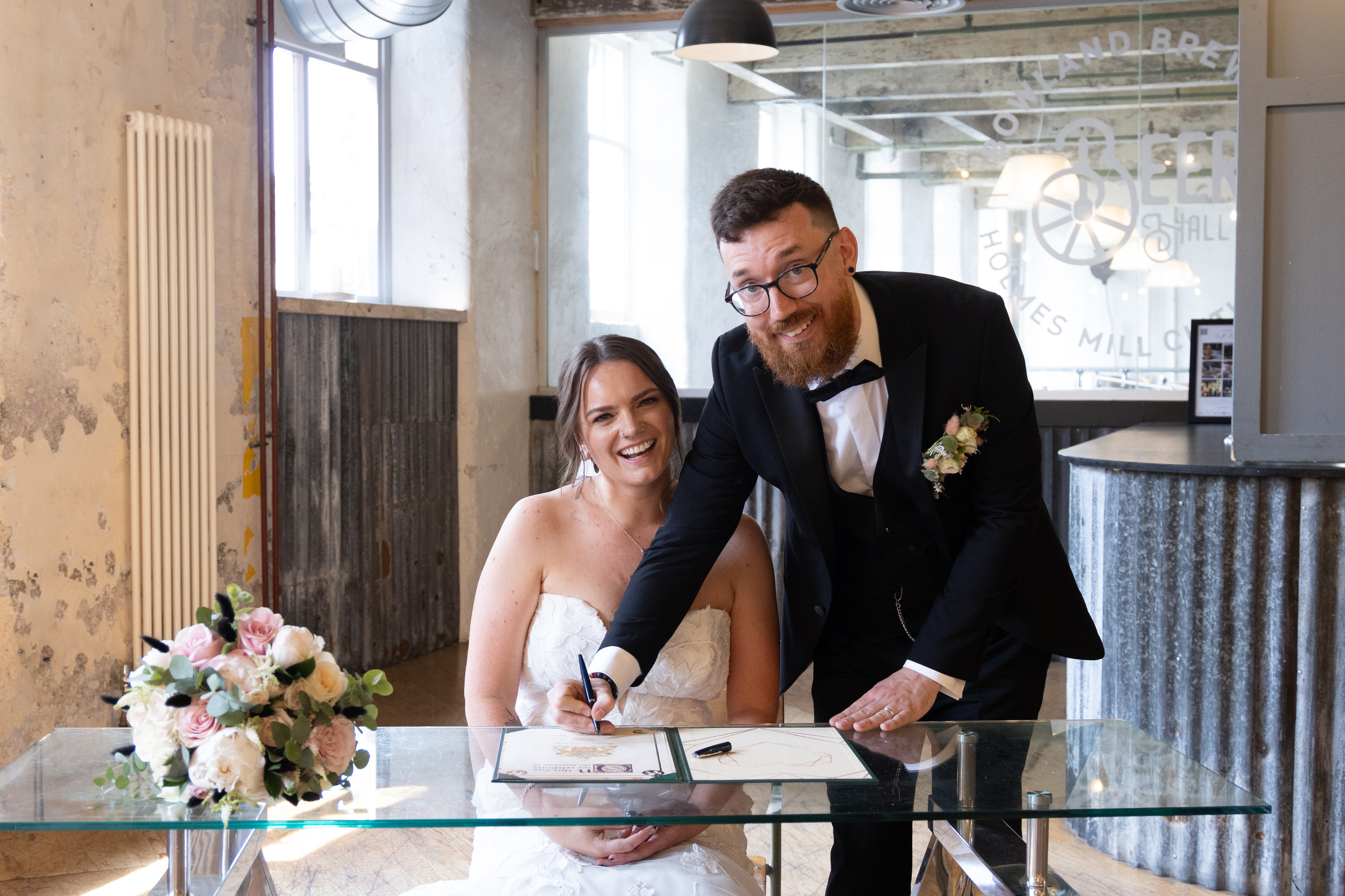 Sarah and Stevie signed the wedding register 