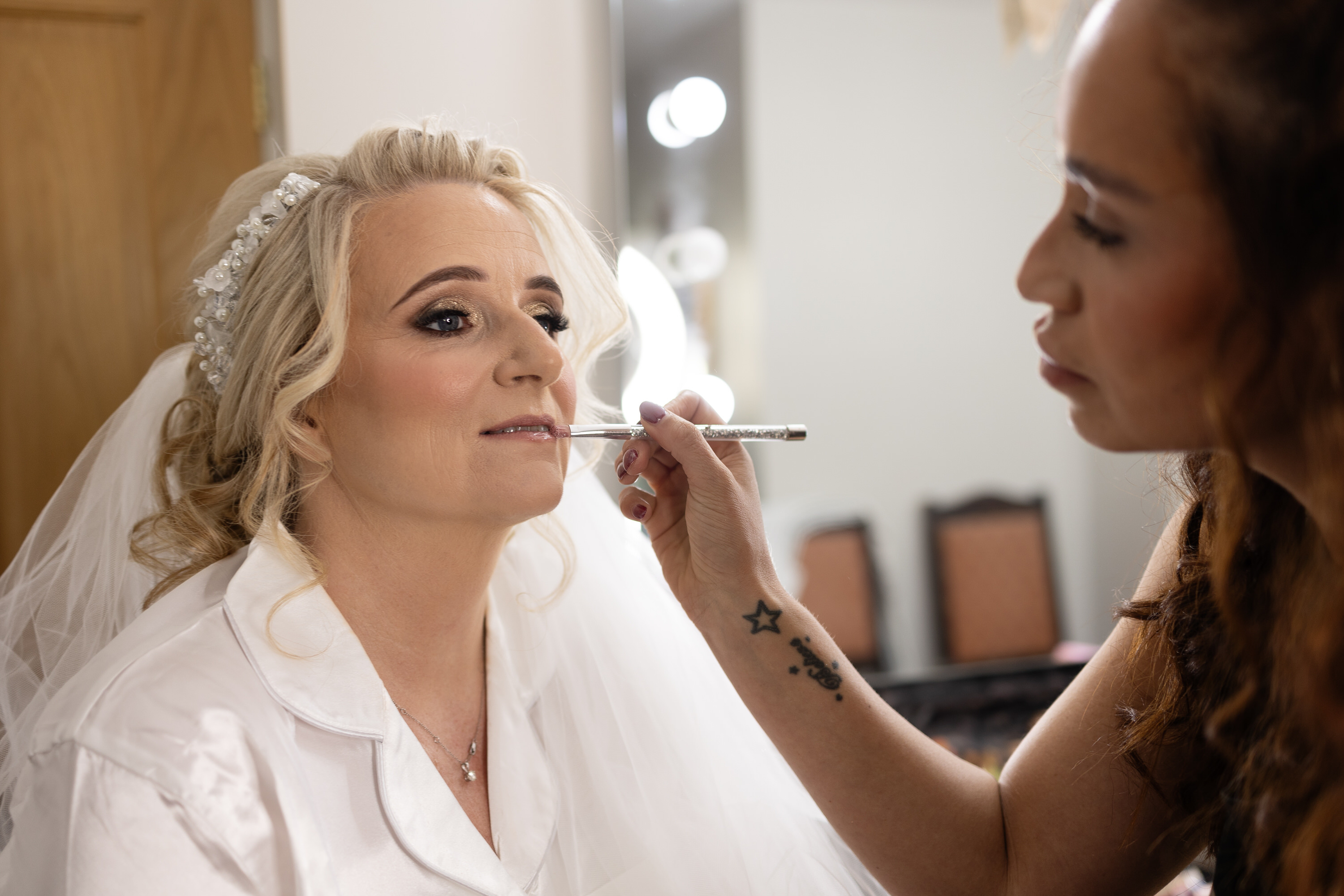 Brenda having her lipstick put on 