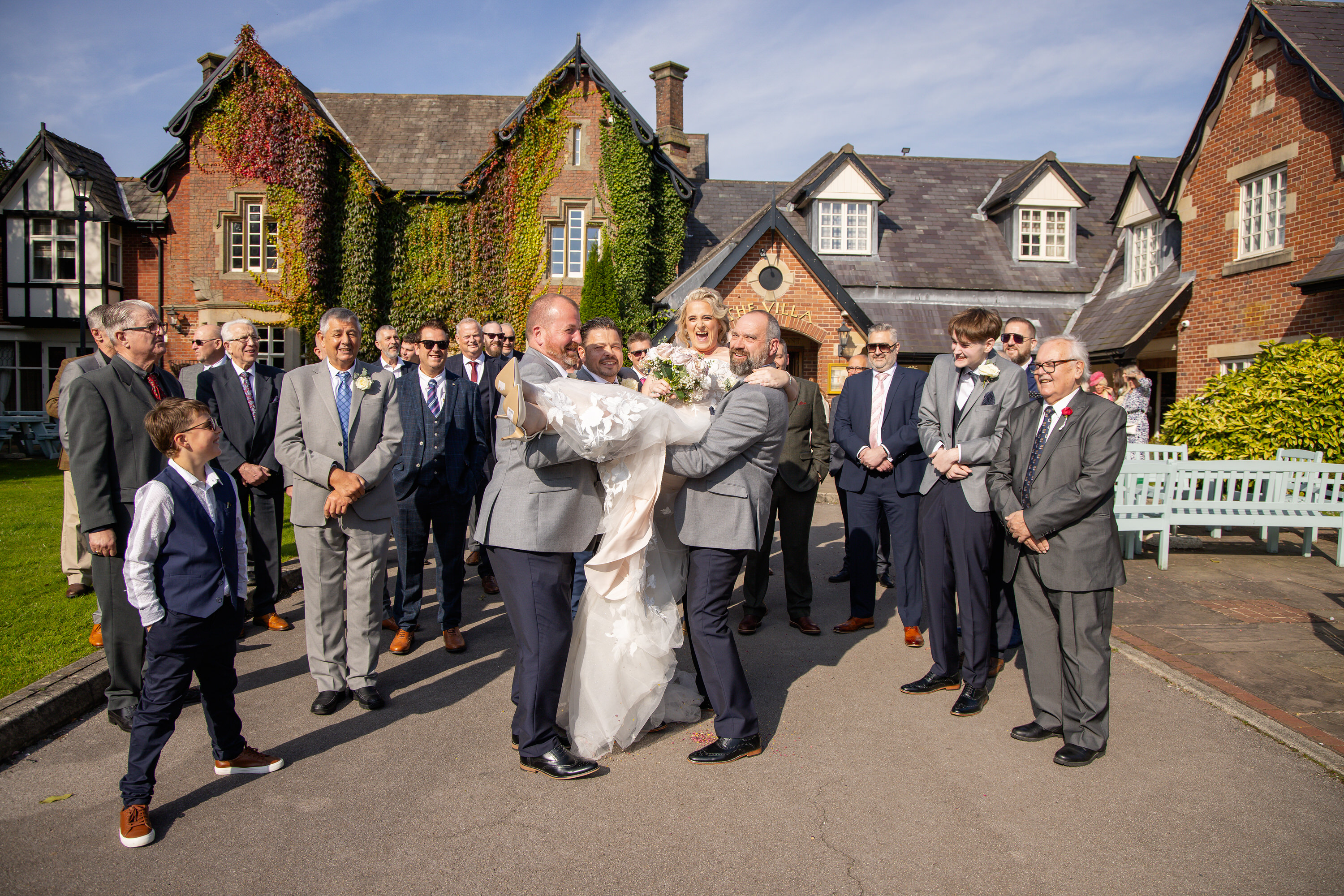 The Bride gets lifted up by the men 