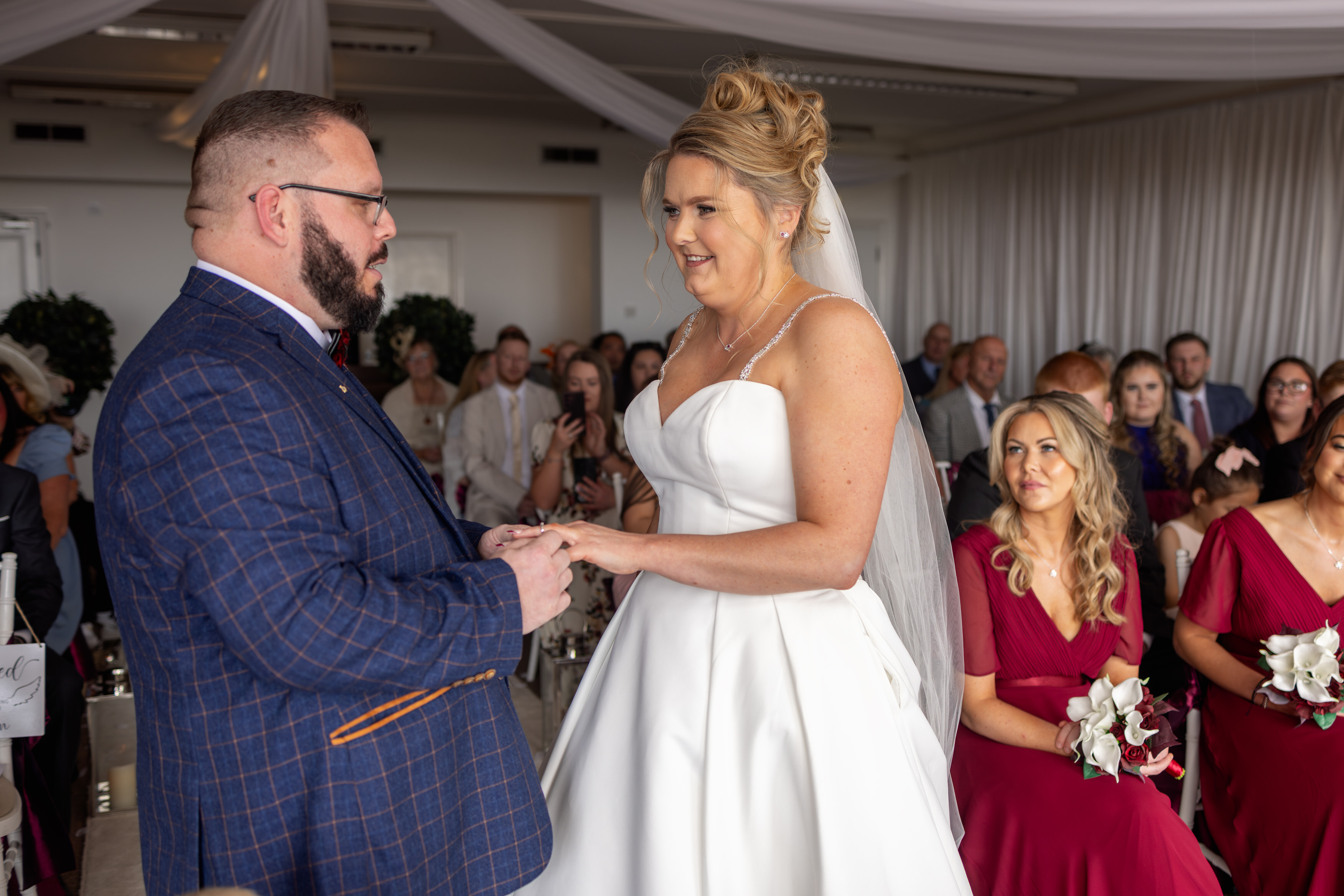 The bride and groom put on their wedding rings
