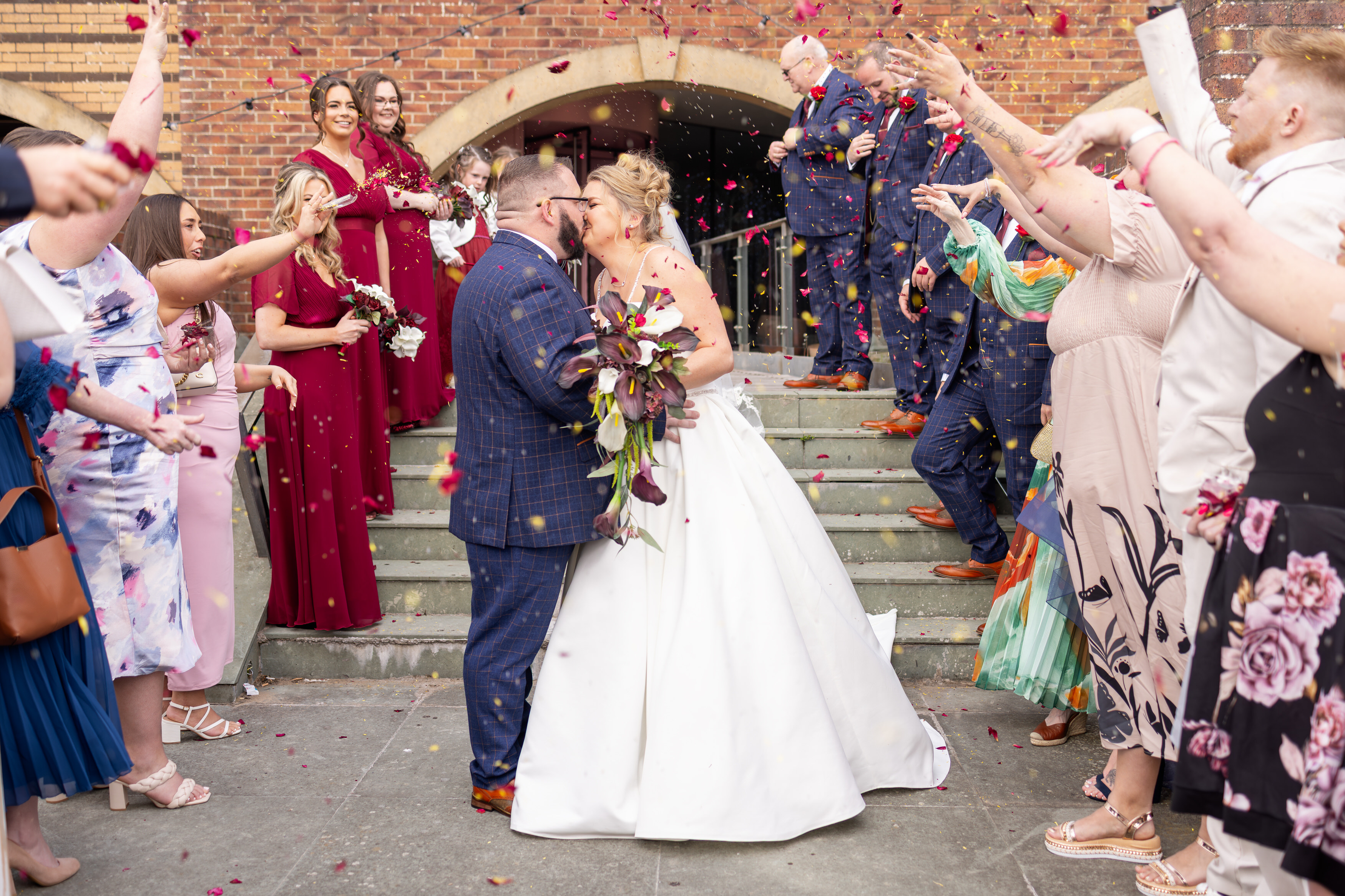 The wedding guests throw confetti 