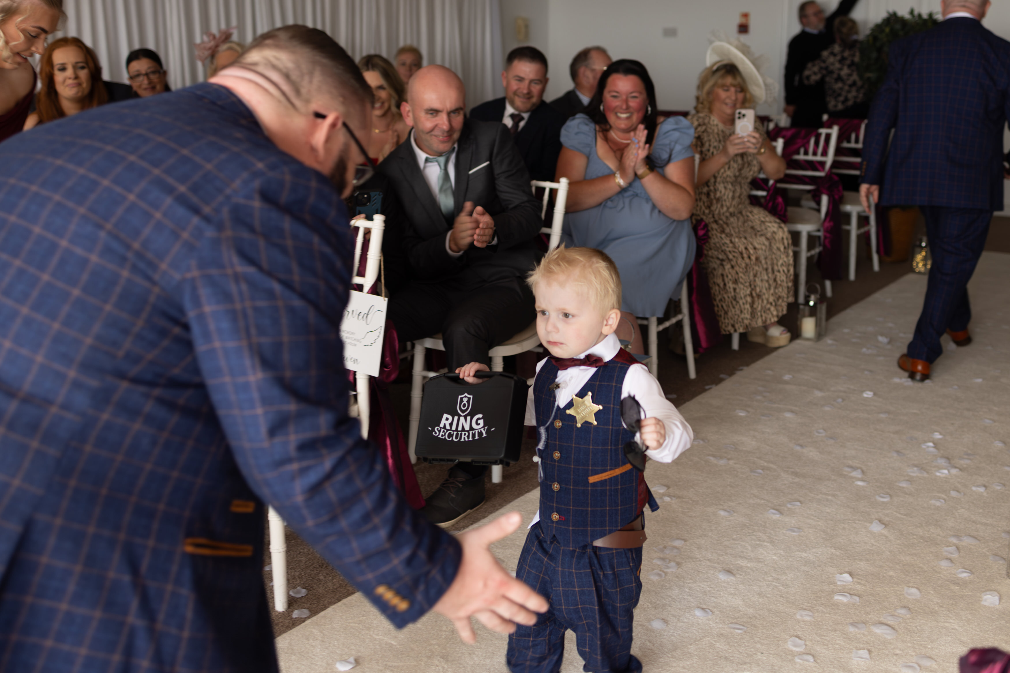 The page boy bringing in the wedding rings 