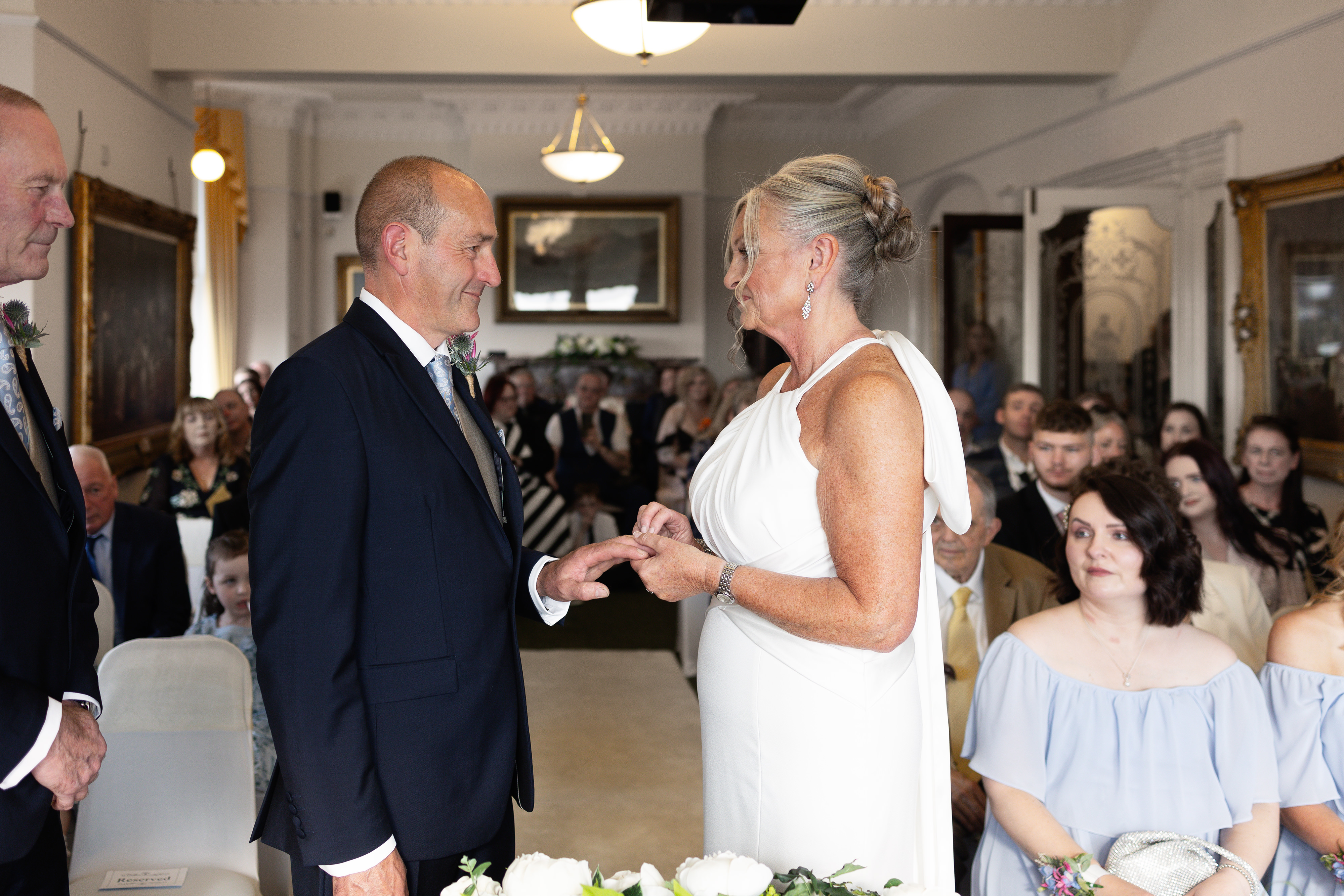 The bride and groom exchange wedding rings 