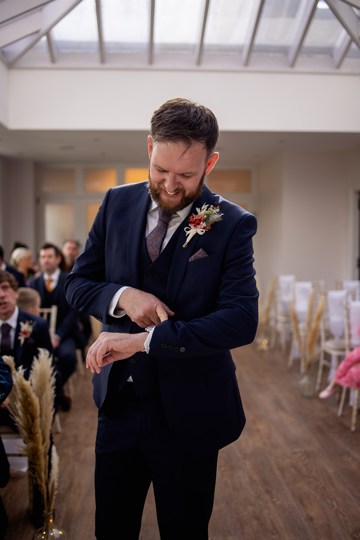 The groom Luke looking at his watch 