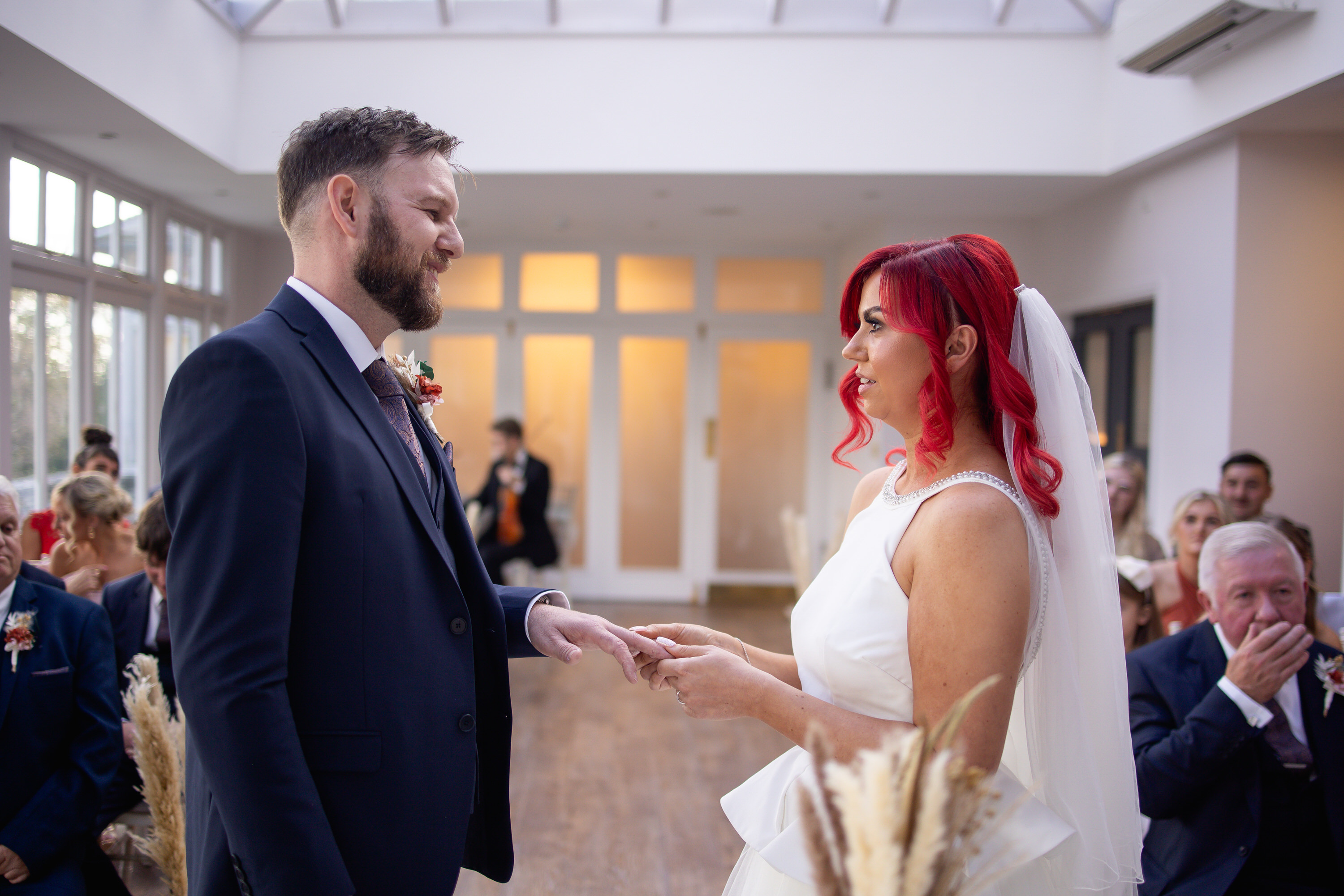 The bride and room exchange wedding rings 