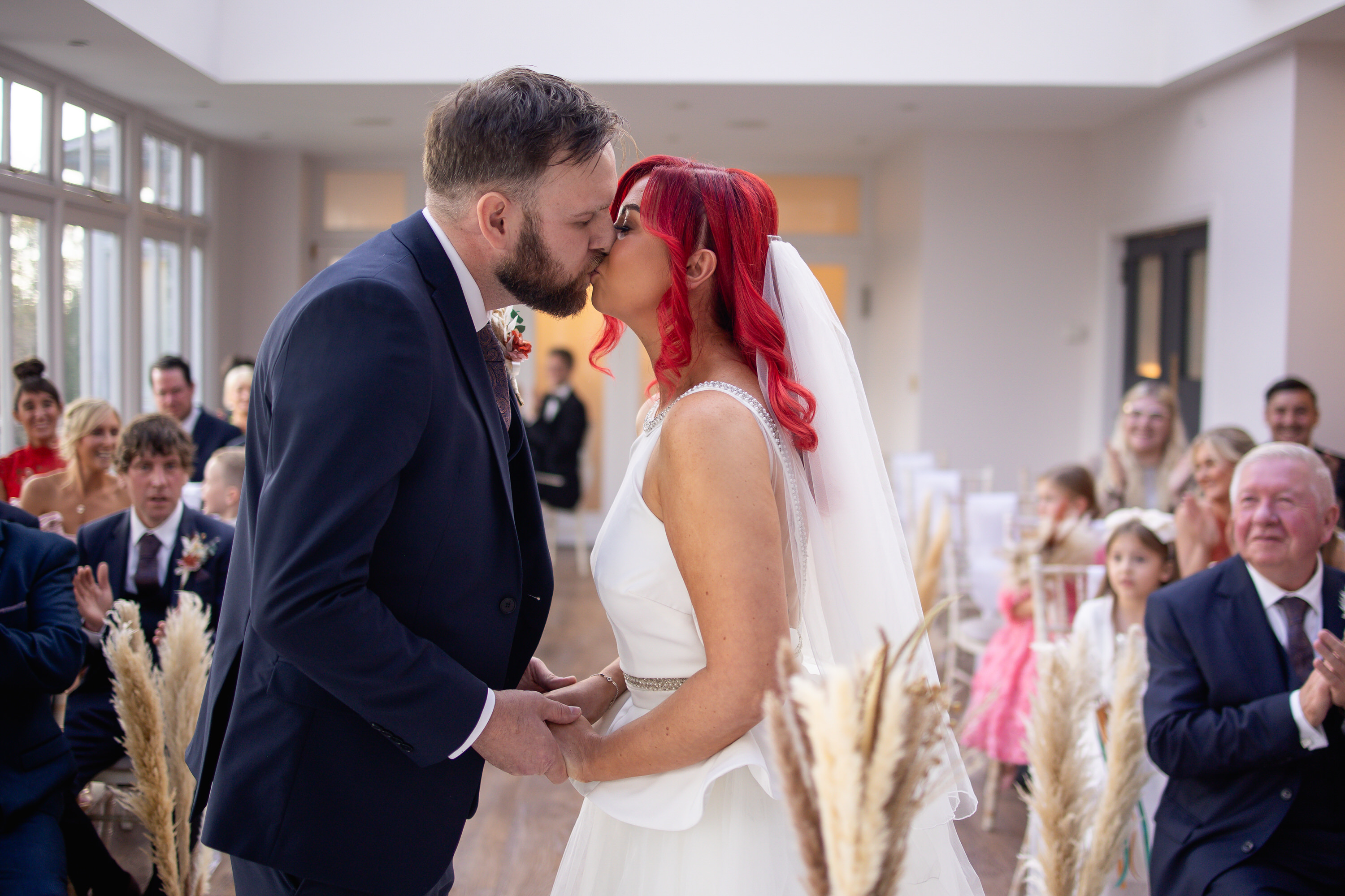 The bride and groom have their first kiss 