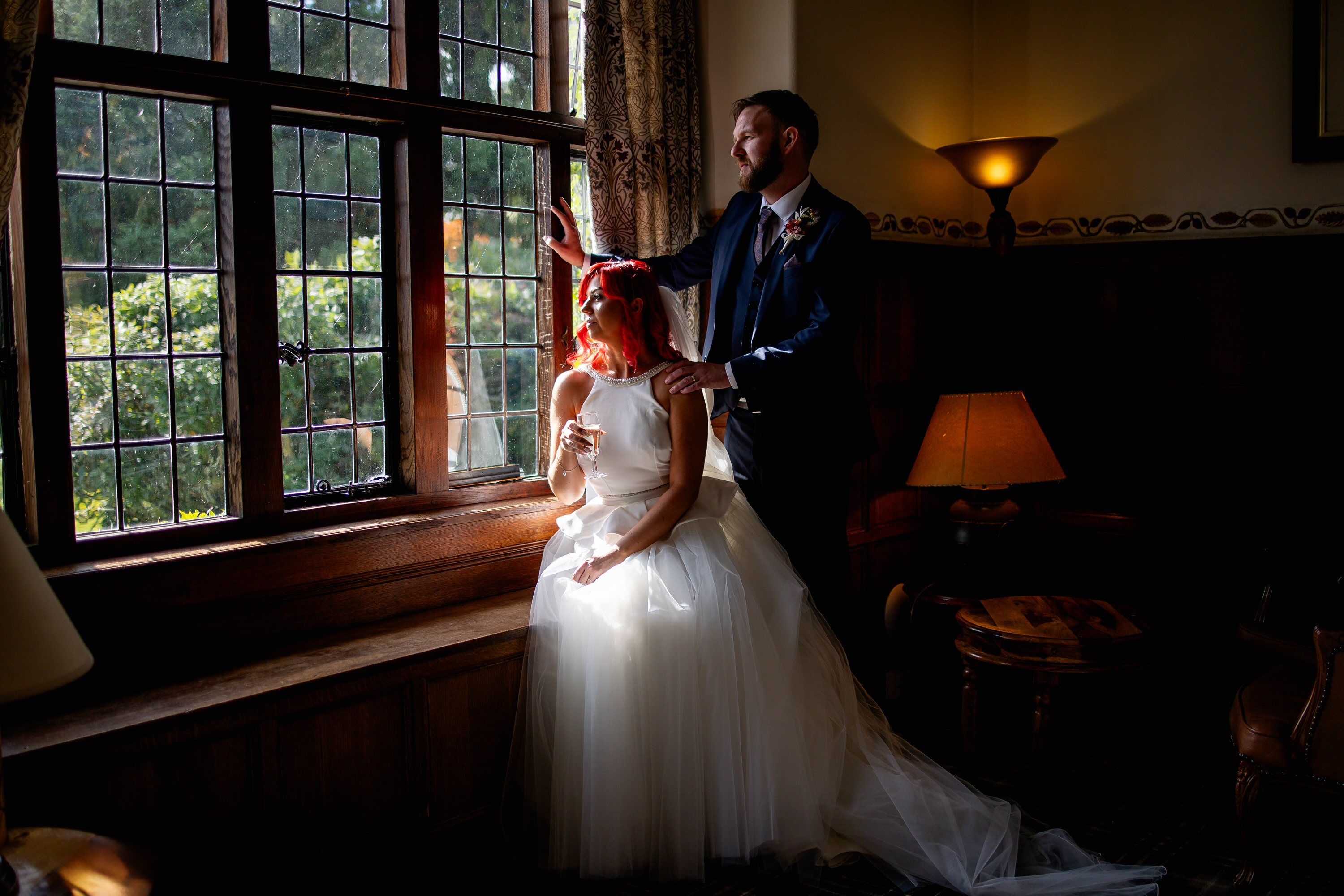 The bride and groom have a drink in the lounge