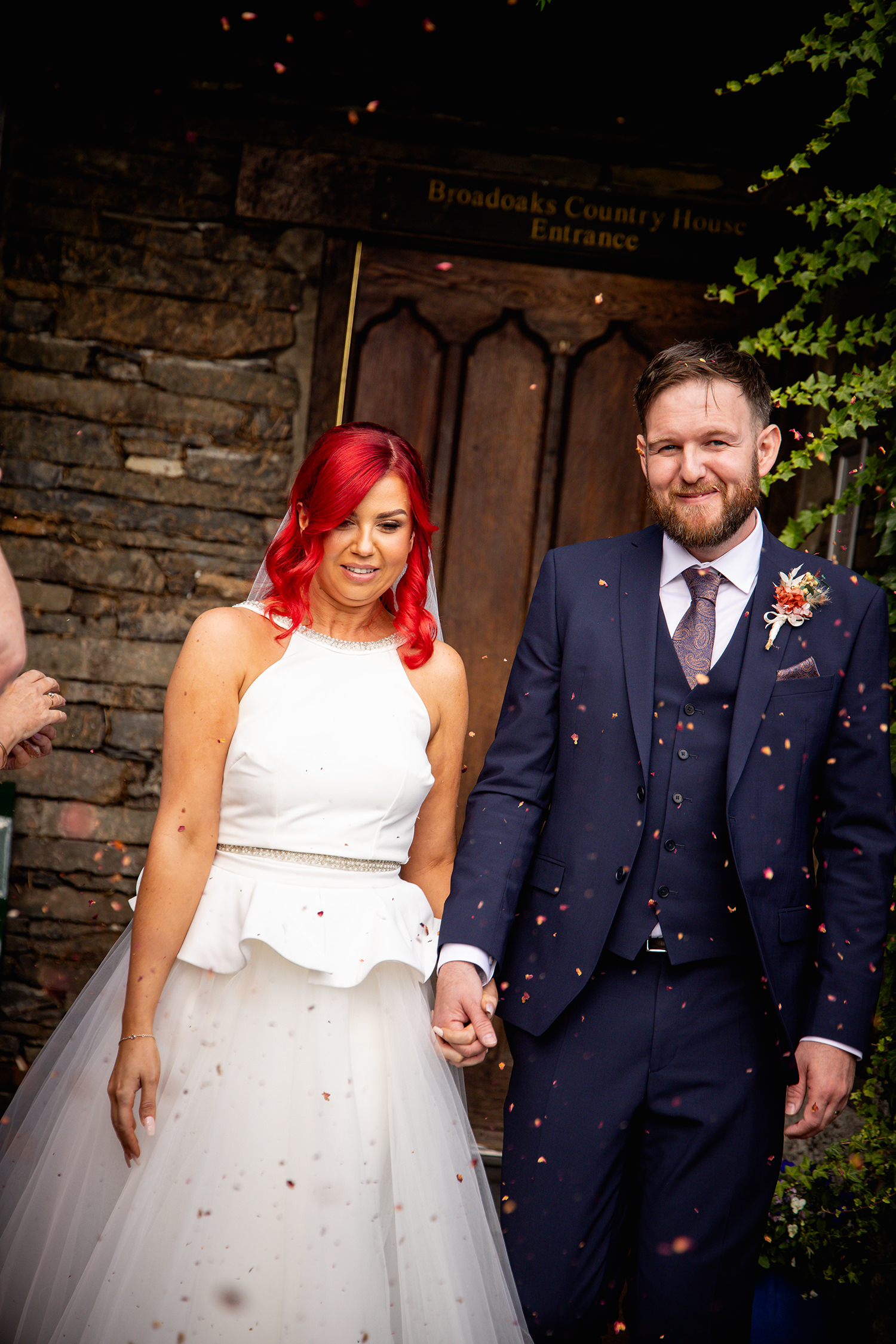 The Bride and groom are greeted with confetti