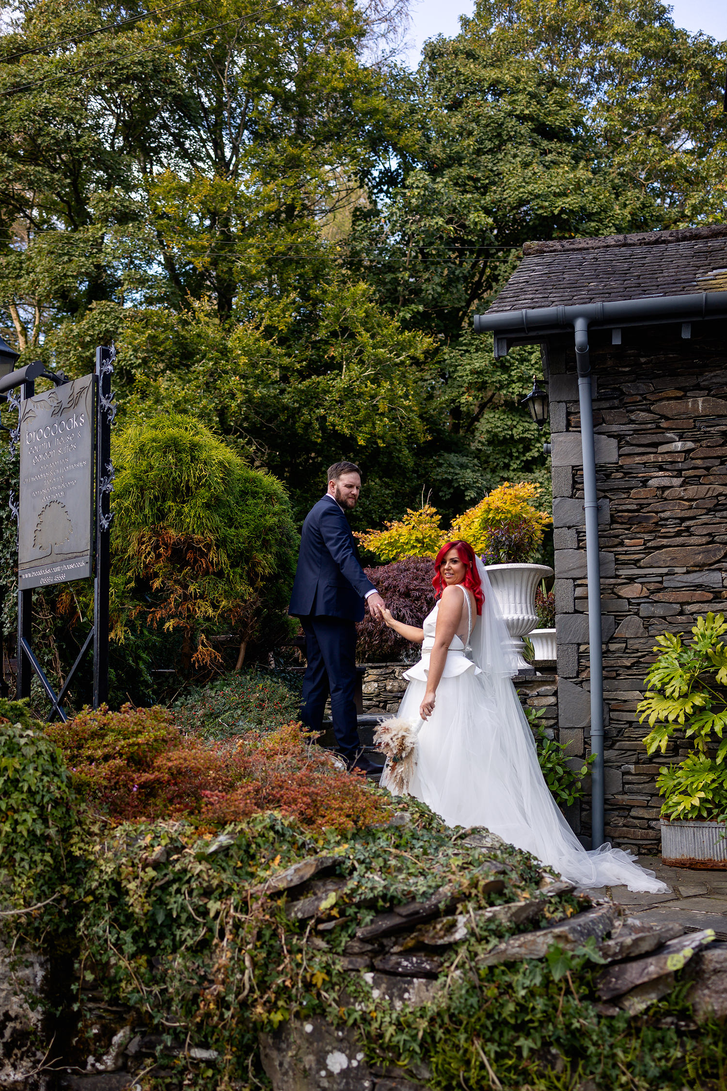 The bride and groom walking up the stairs