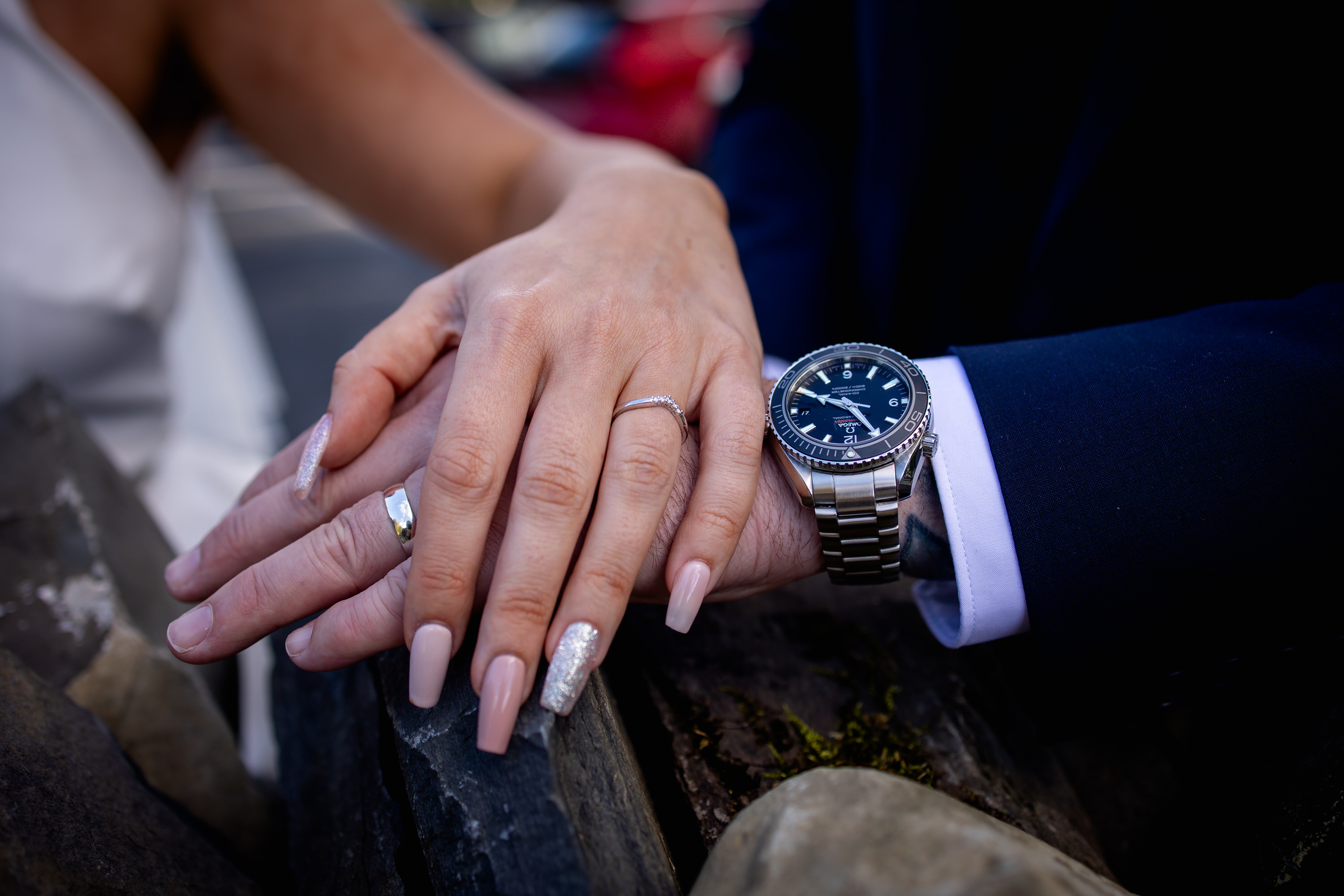 The bride and groom show off their wedding rings 