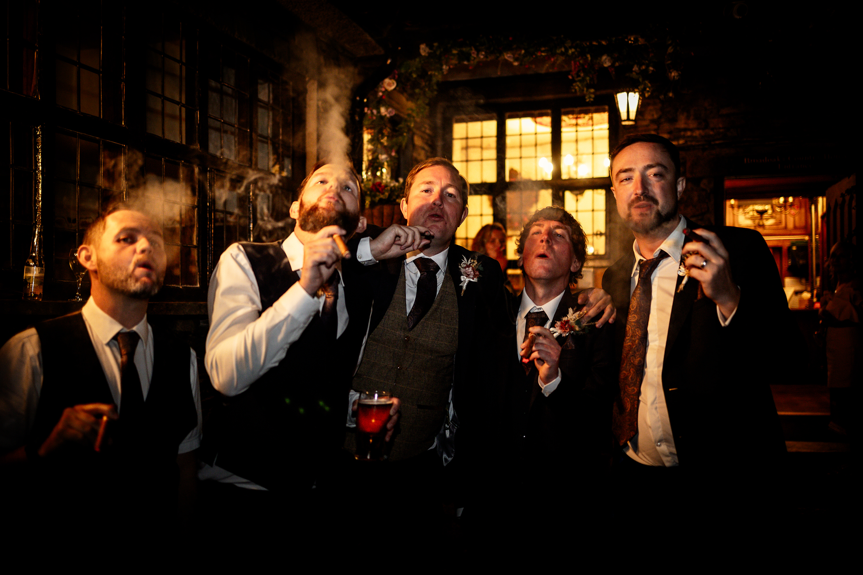 The groom enjoys a cigar with his friends 