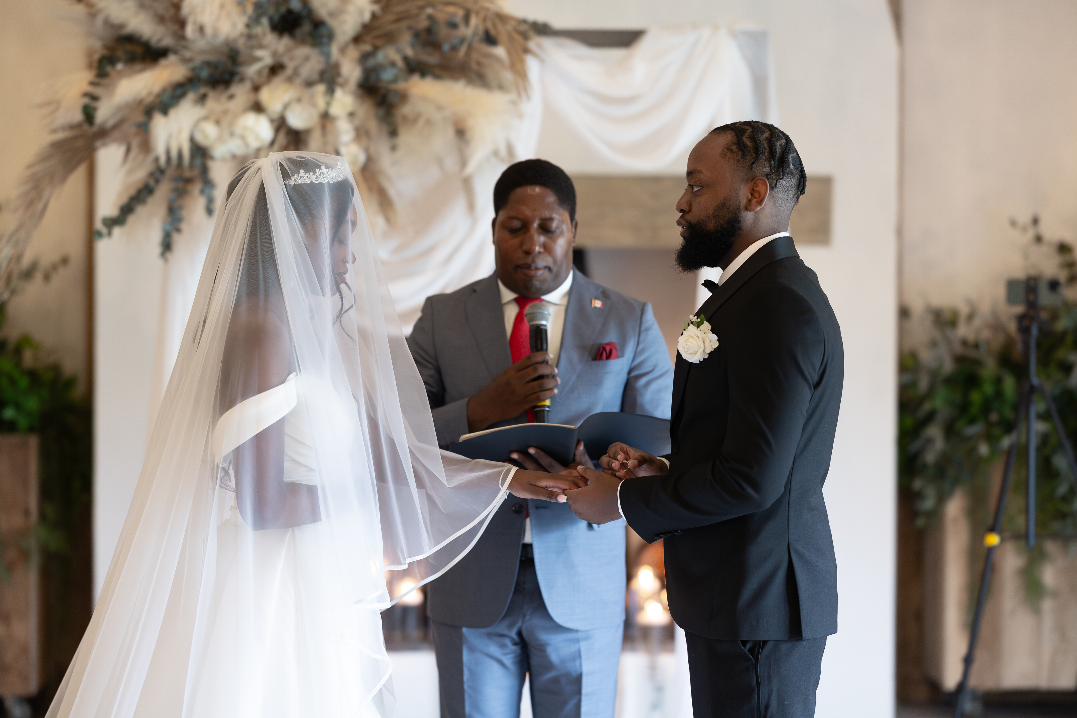 The bride groom exchange their wedding rings 