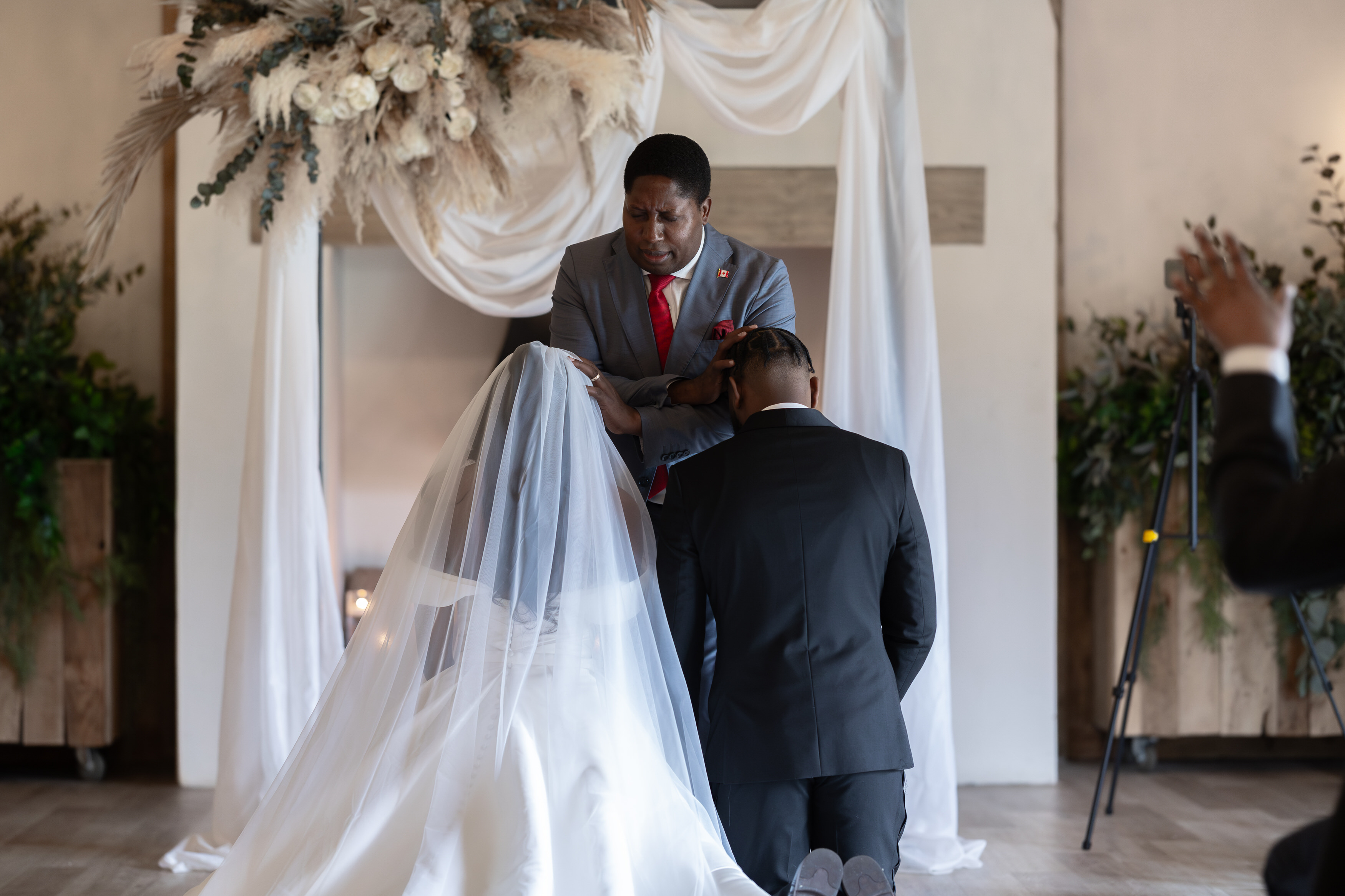 The bride and groom kneel down for prayers