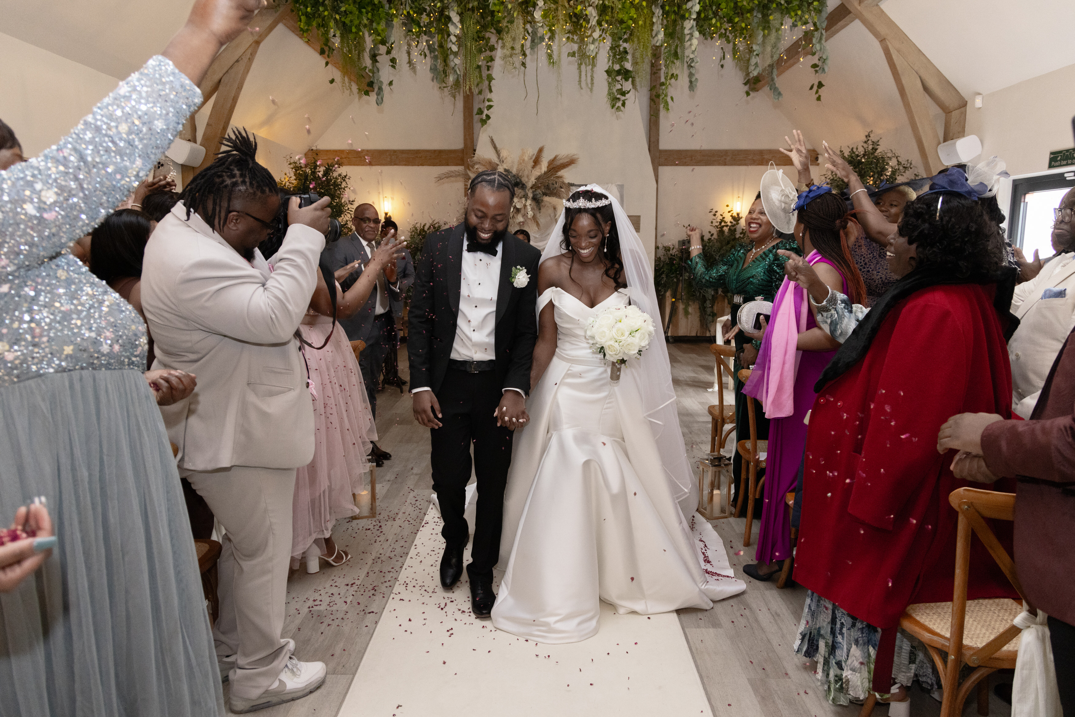 Wedding guests throw confetti at the bride and groom 