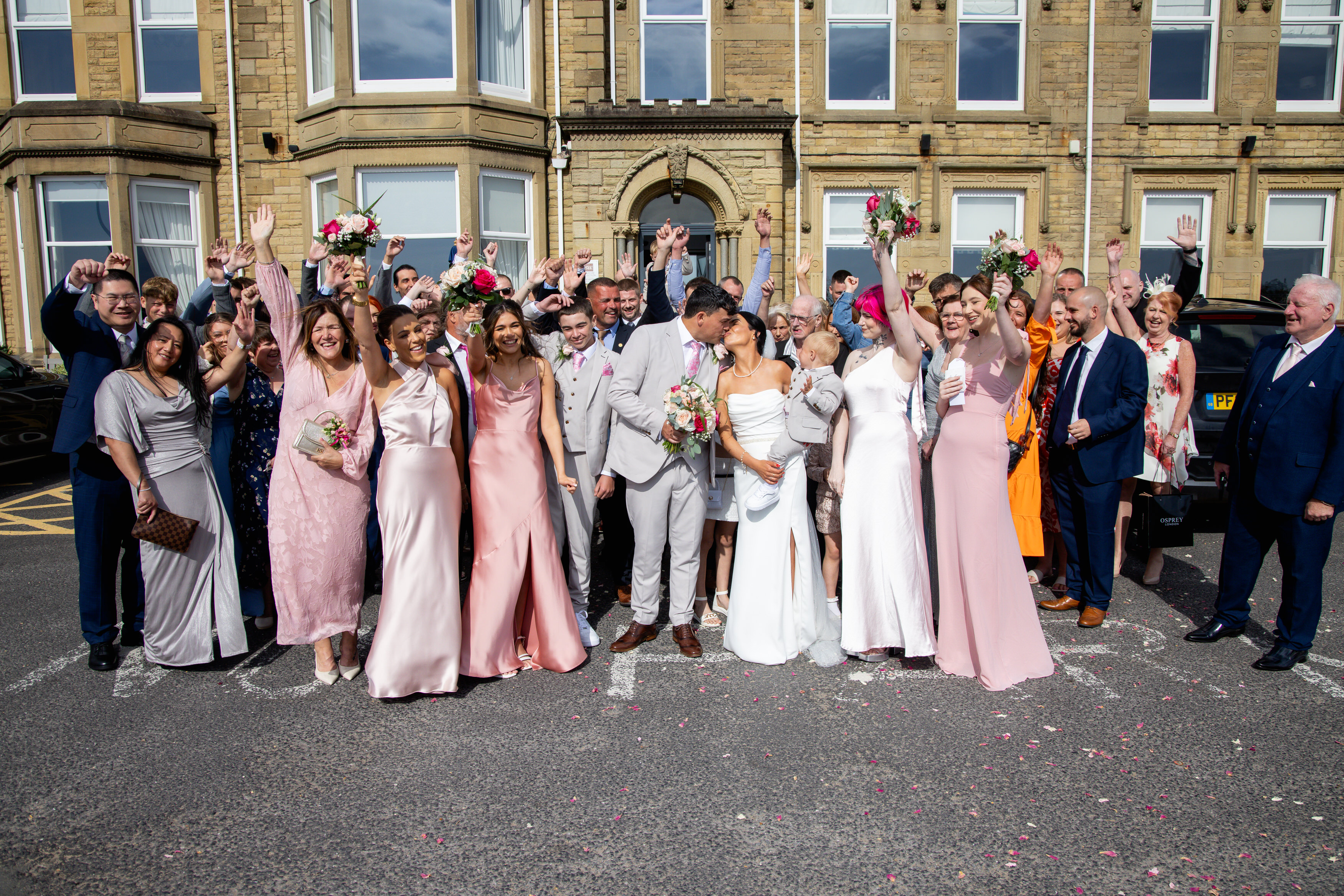 A group wedding photo outside the glendower hotel 
