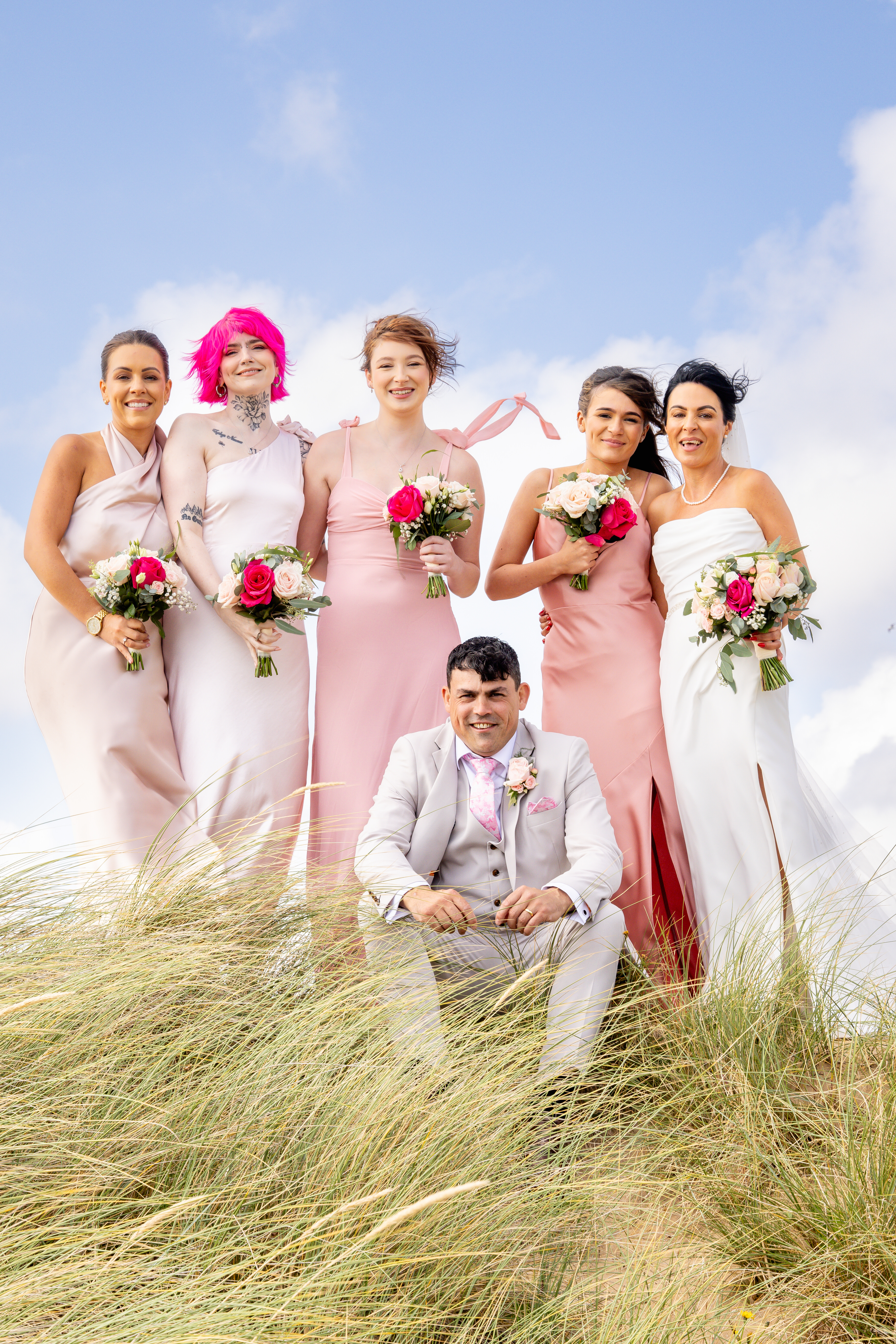 The bride and groom with the bridesmaids