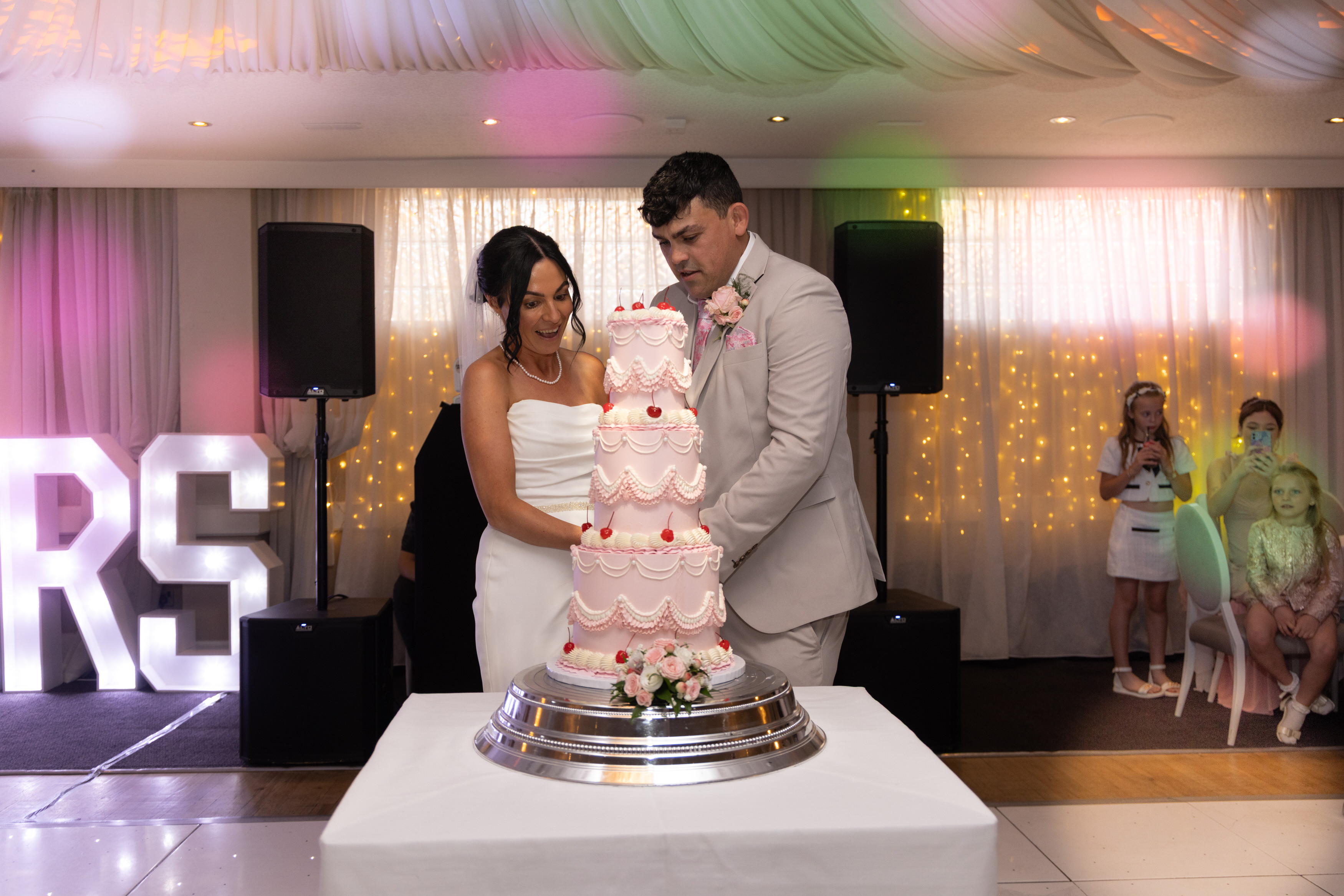 Sarah and Andrew cut their wedding cake 