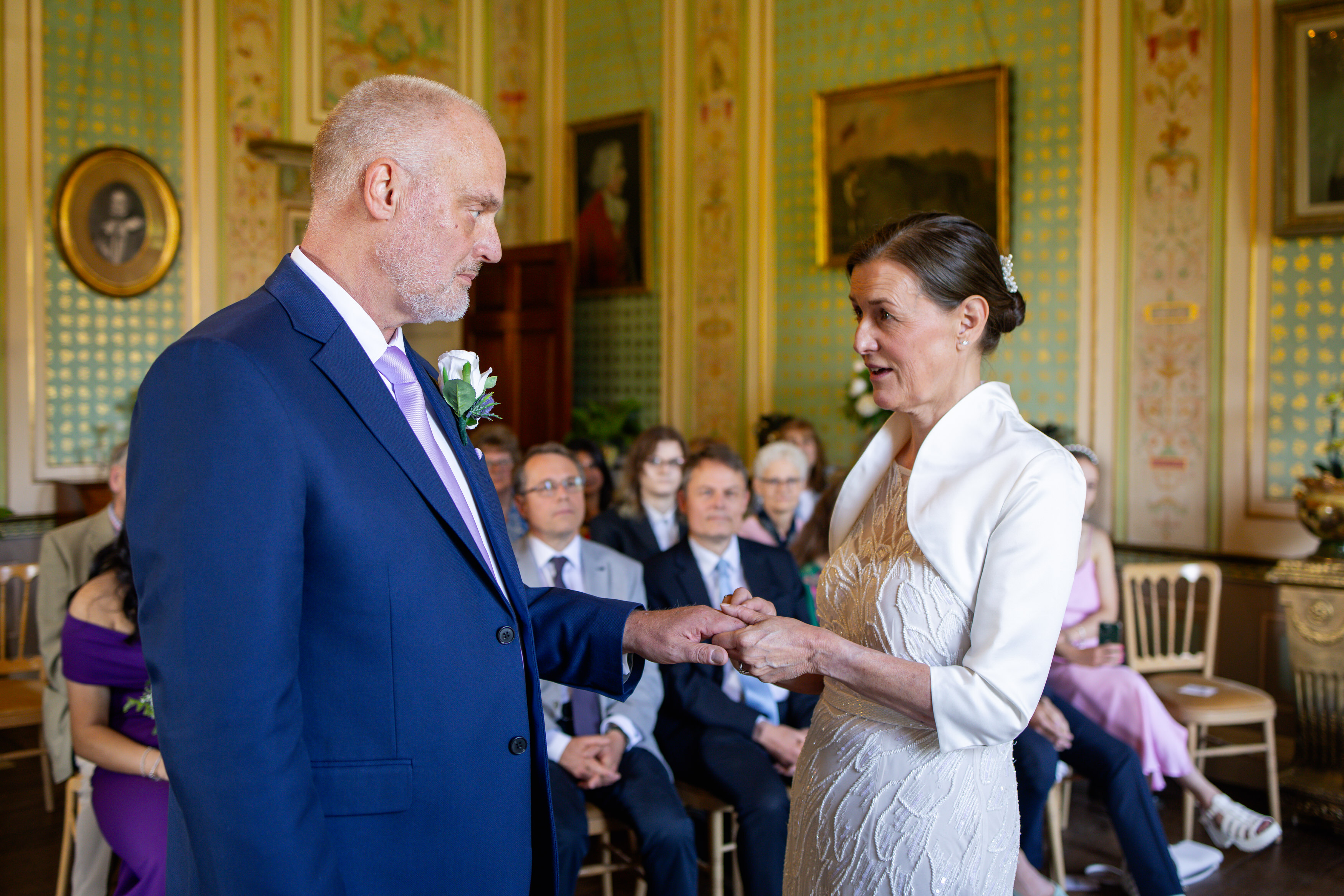 Helen puts Michael's wedding ring on his finger