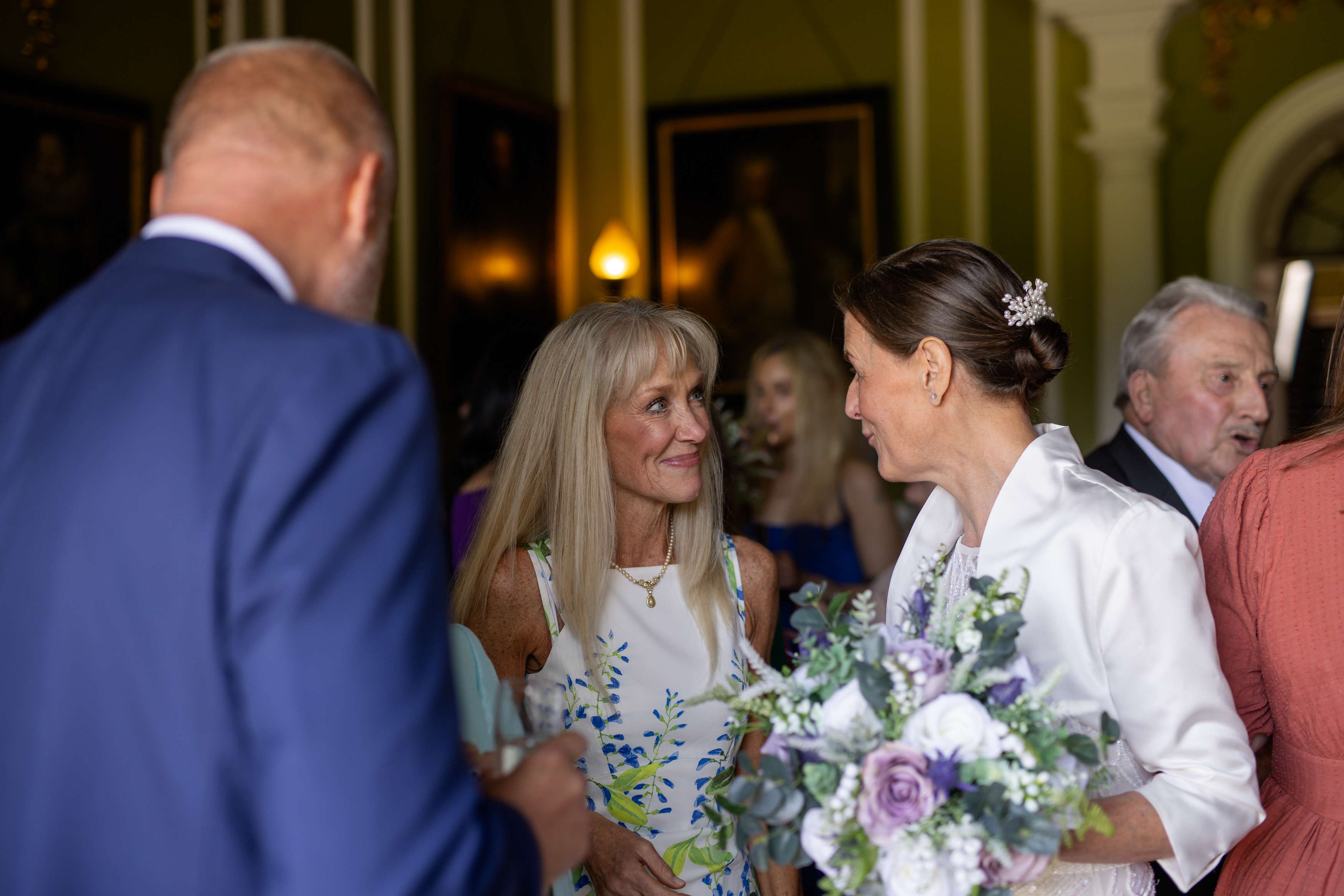 Some of the guests come and congratulate the bride and groom 