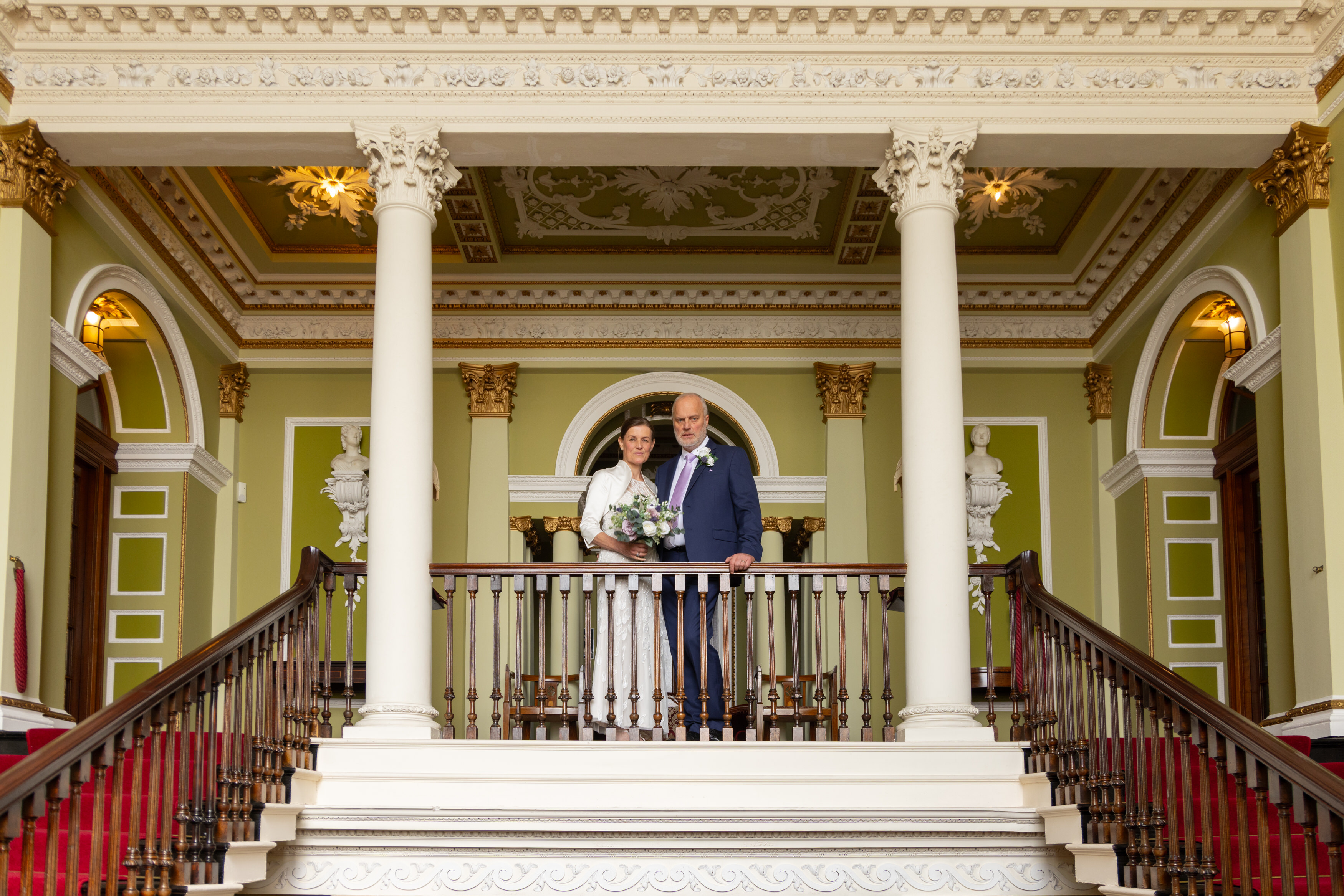 The Bride stands on the balcony for a wedding photo 