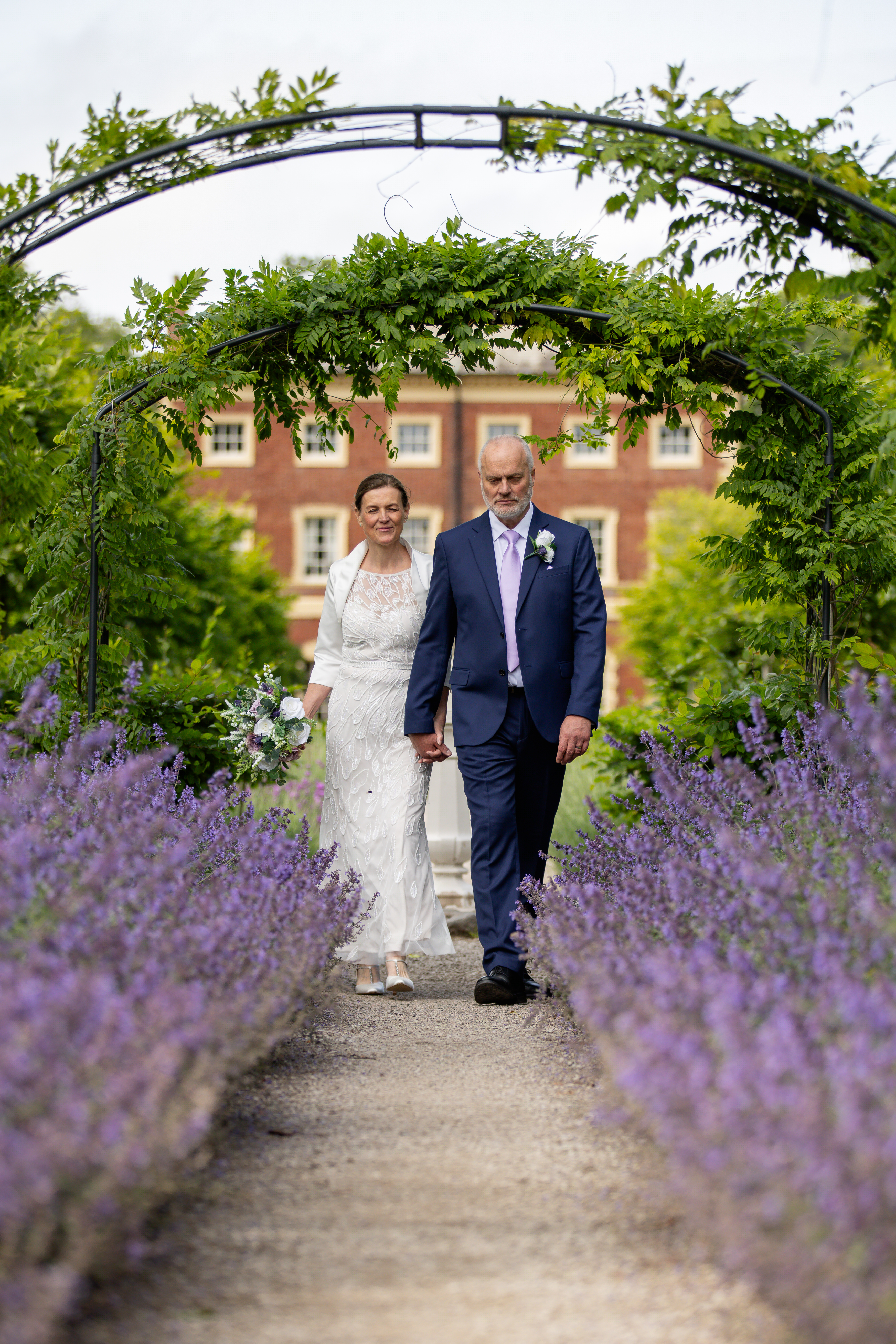 Helen and Michael walk down the path lavender flowers 
