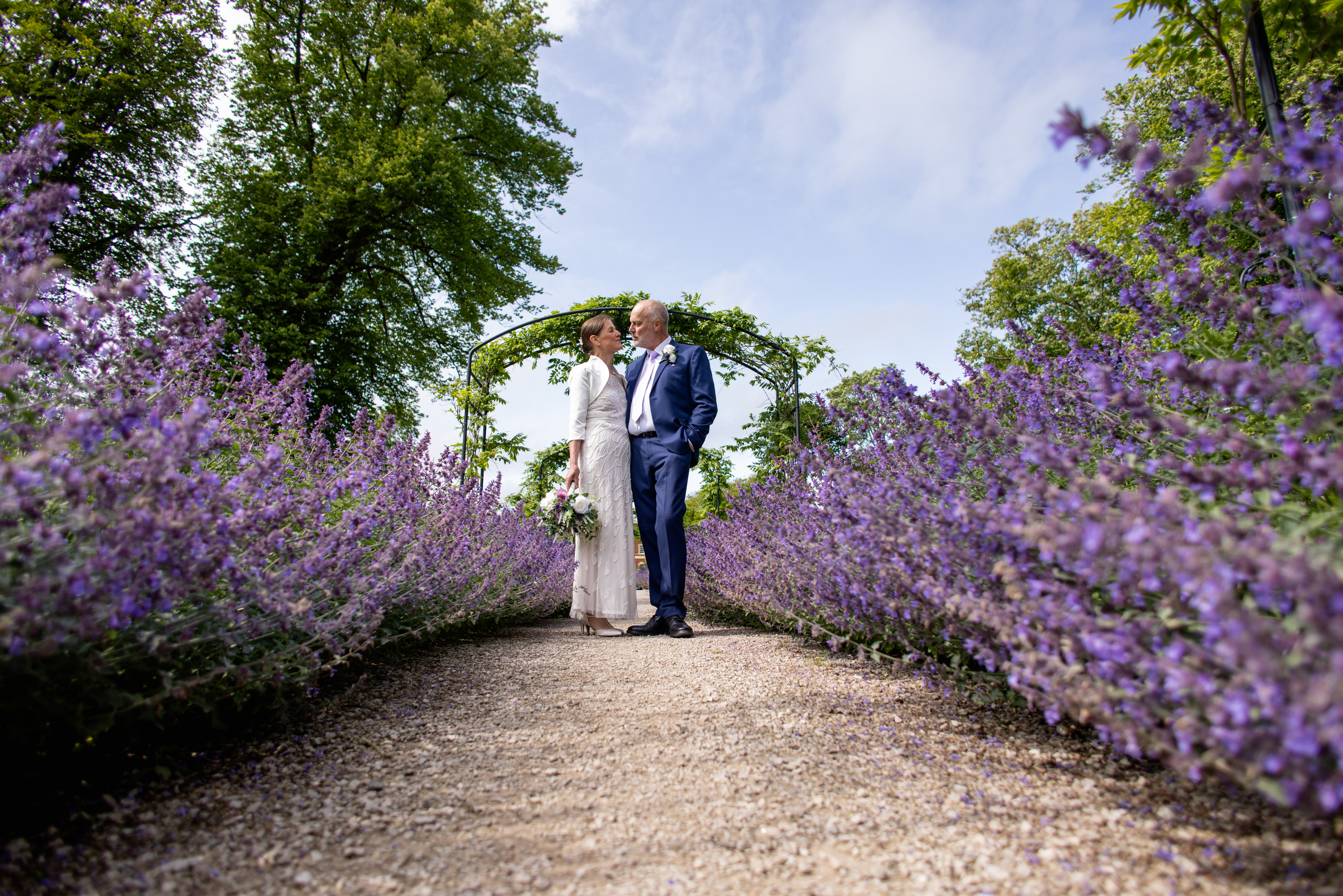 Helen and Michael walk down the path lavender flowers 