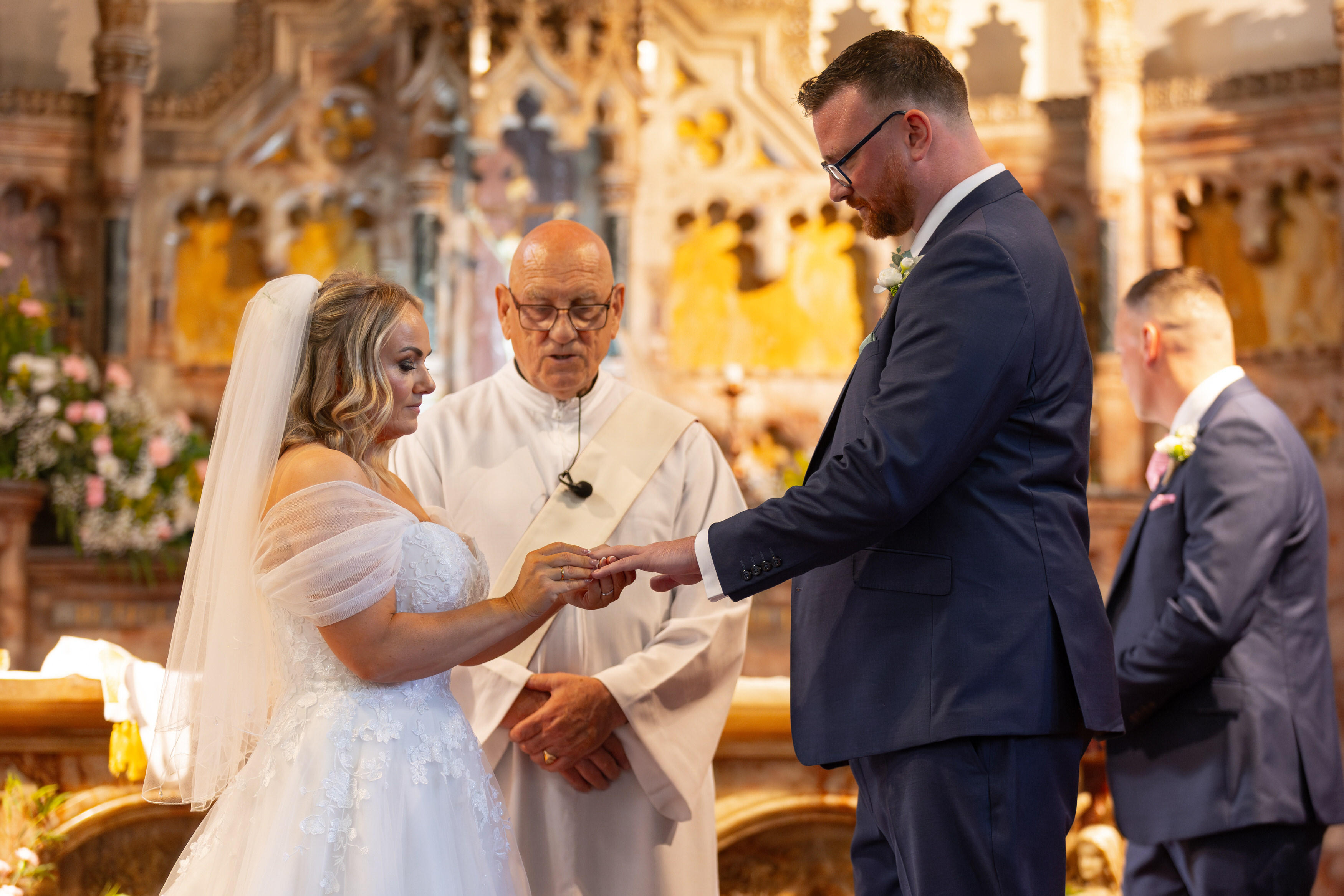Jeanette puts Sean's wedding ring on his finger 