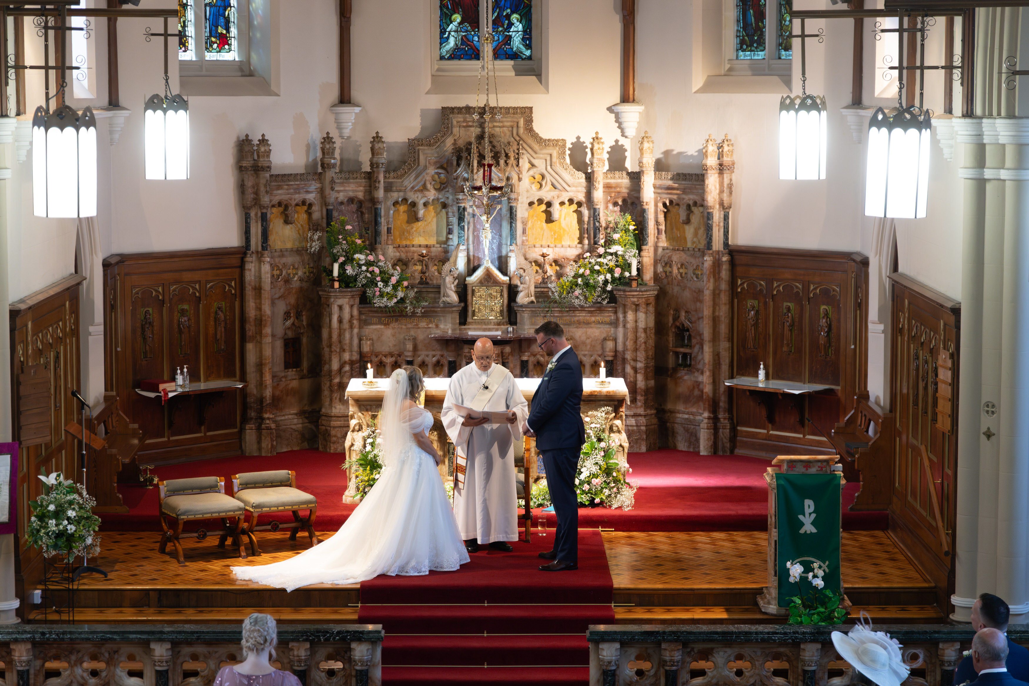 Jeanette and Sean stand at the altar to read their vows