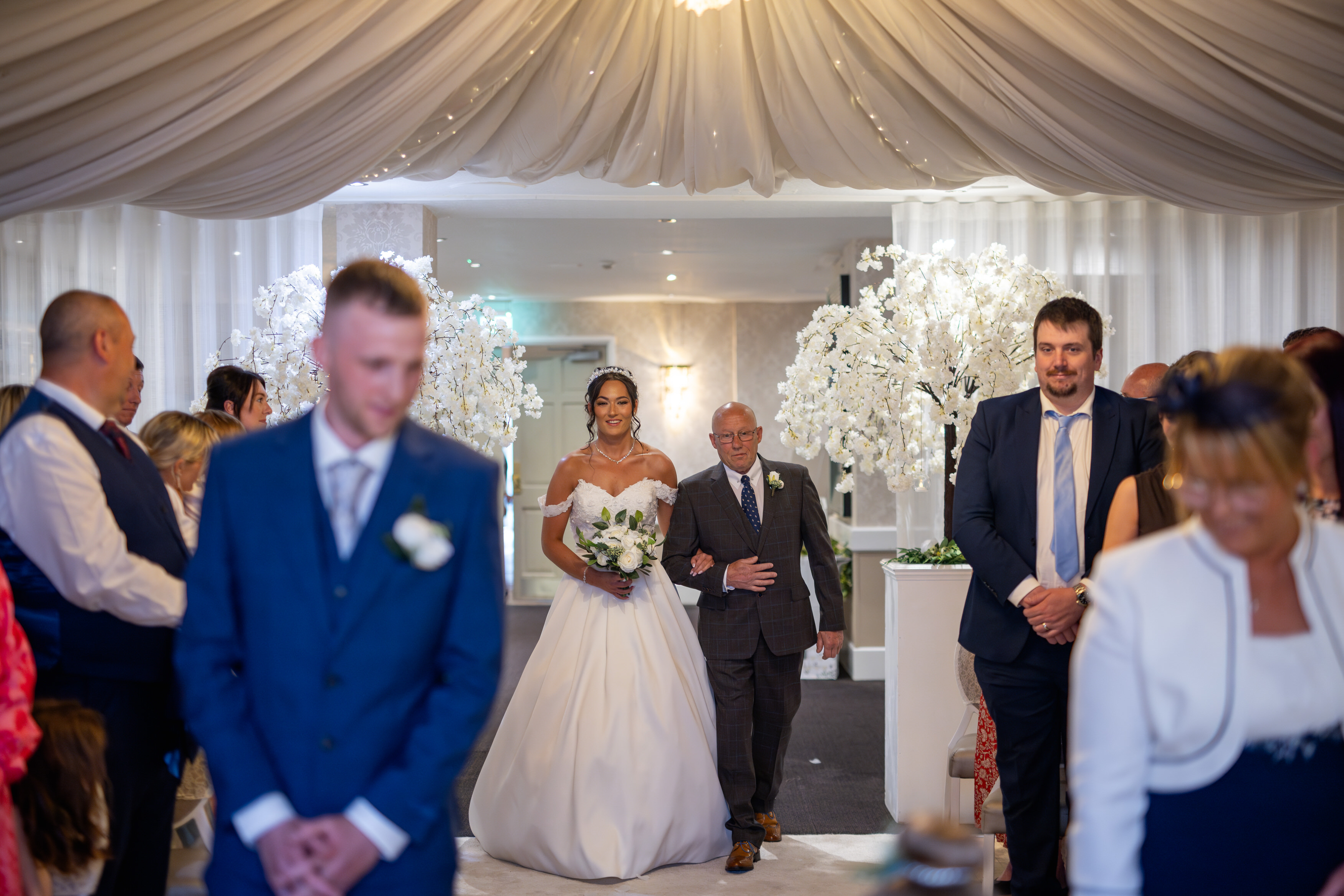 The Bride enters the ceremony room with her father 