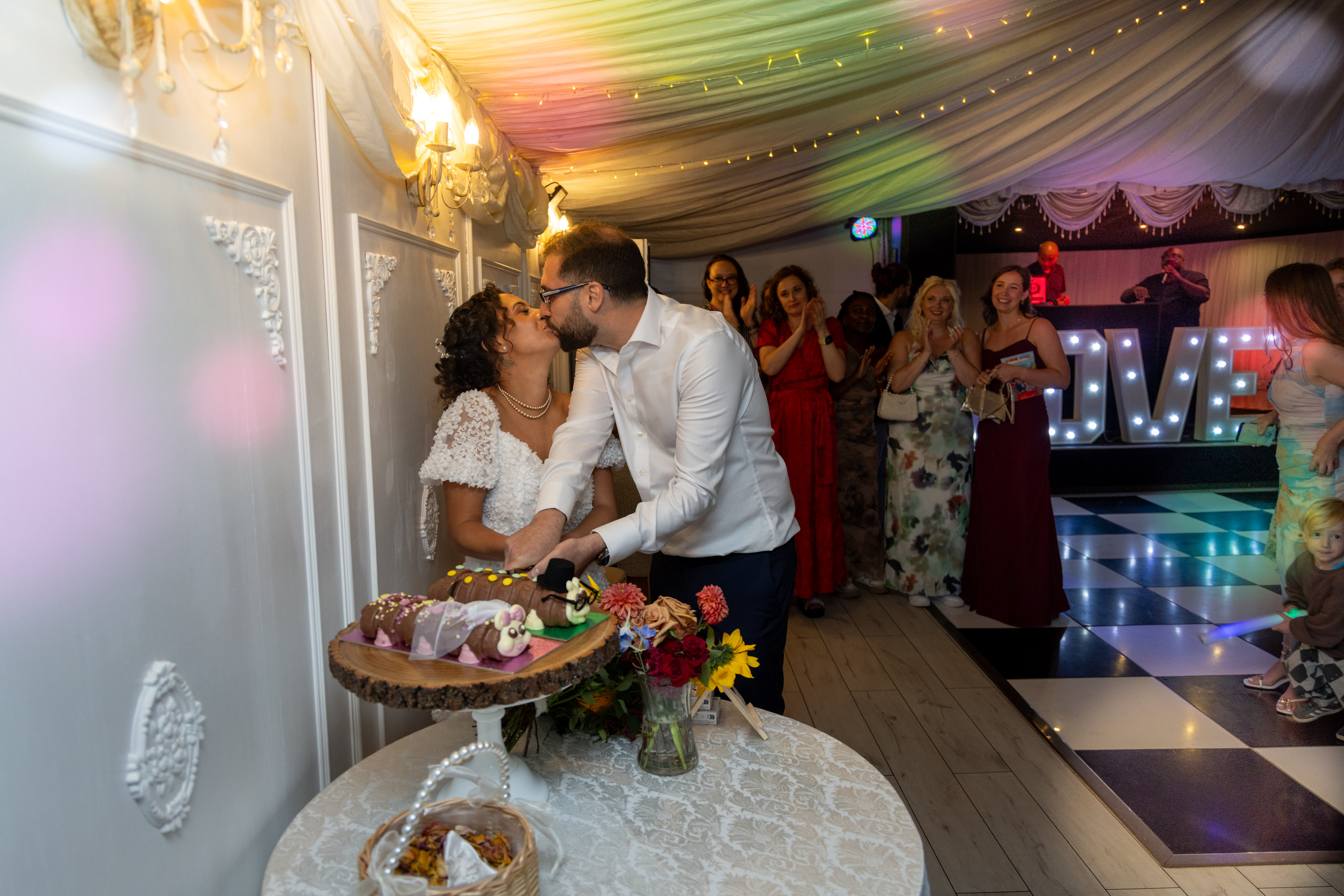 The bride and groom cut their wedding cake 