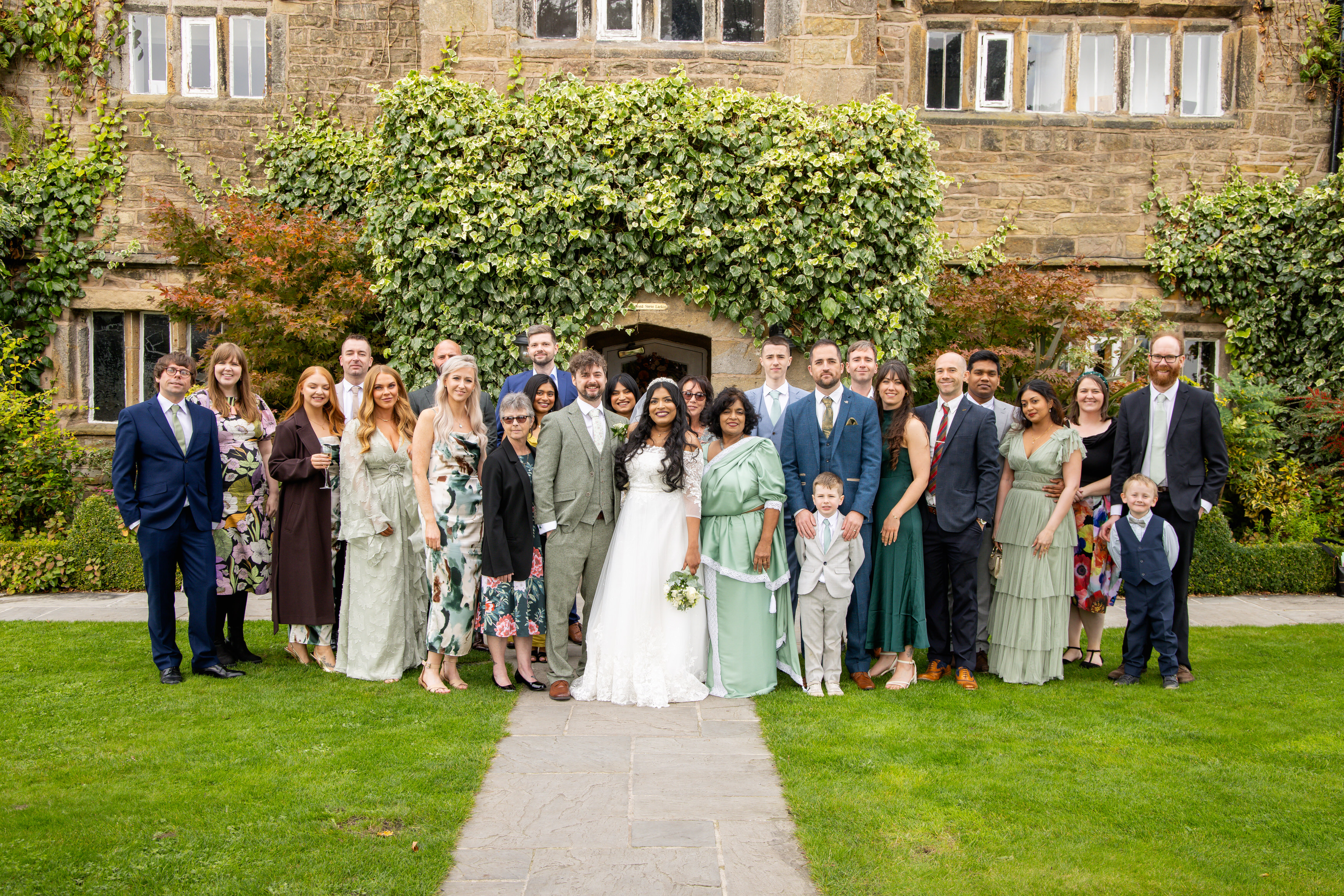 Udara and Tony pose for wedding photos with the wedding guests 