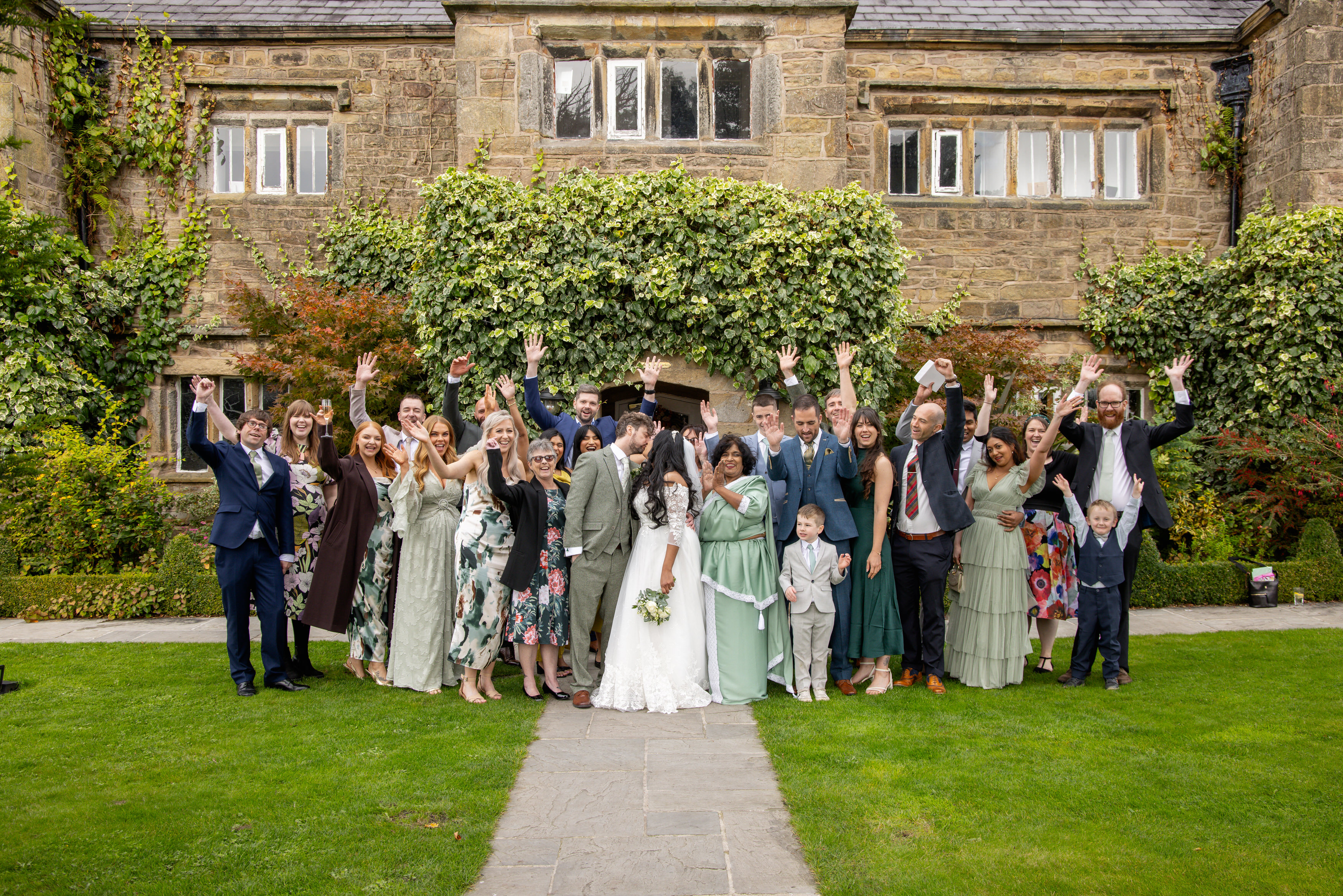 Udara and Tony pose for wedding photos with the wedding guests 
