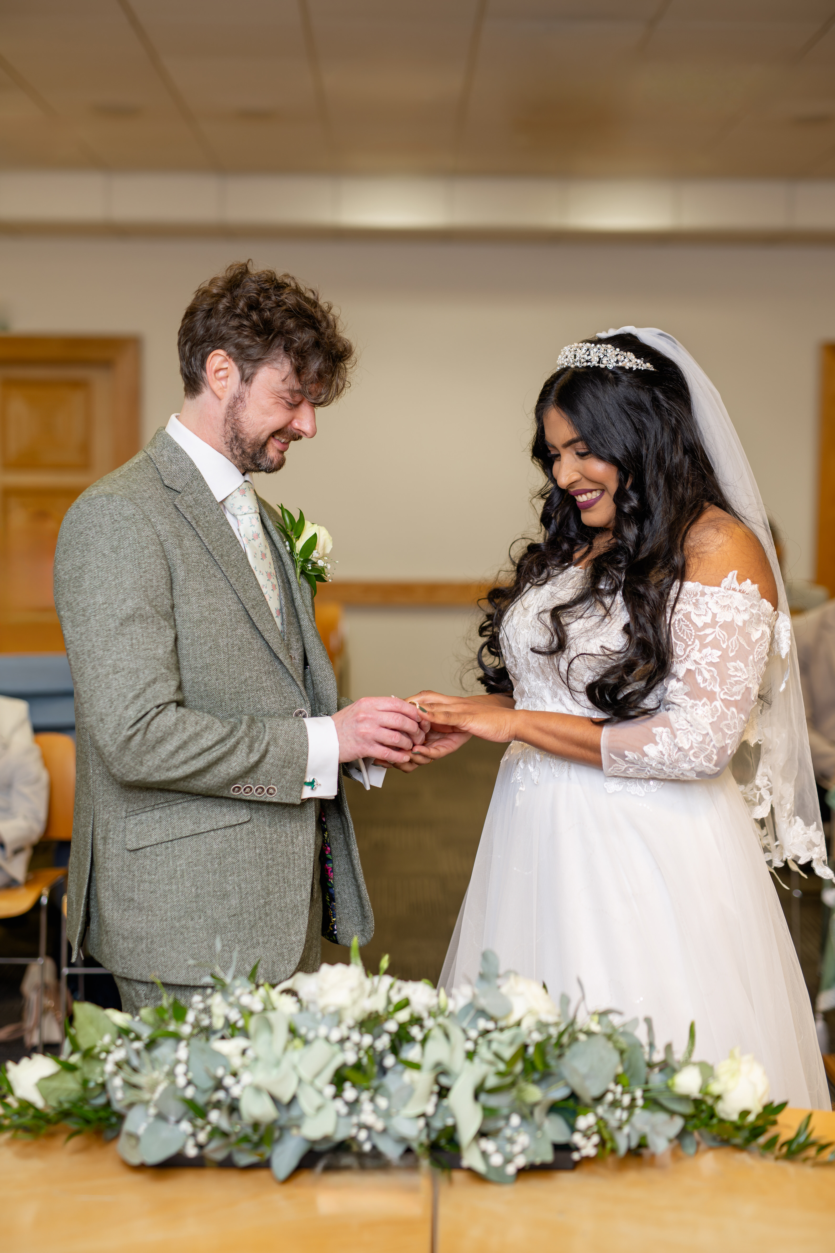 The bride and groom exchange wedding rings 
