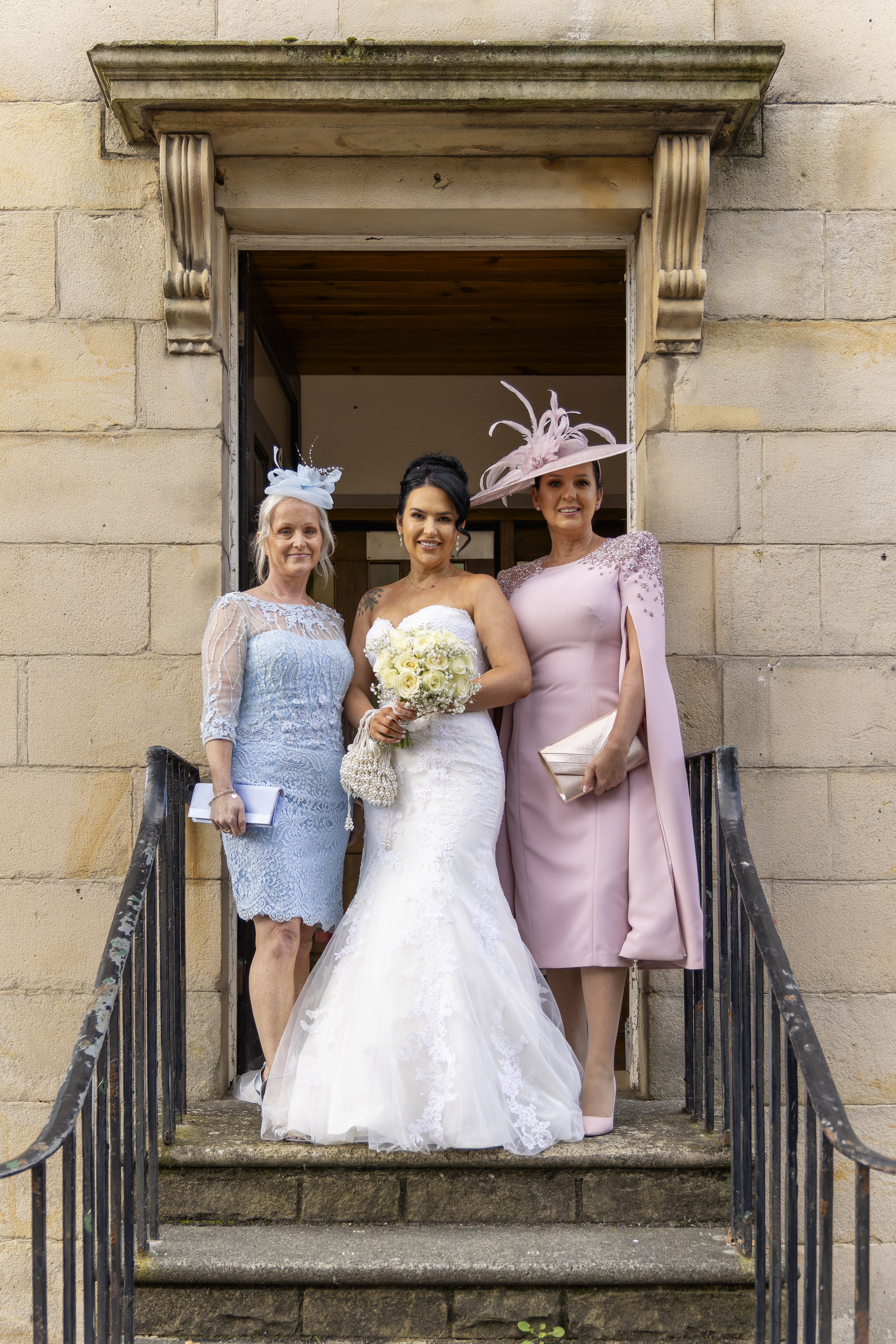 The bride and the mother's pose for a photo 